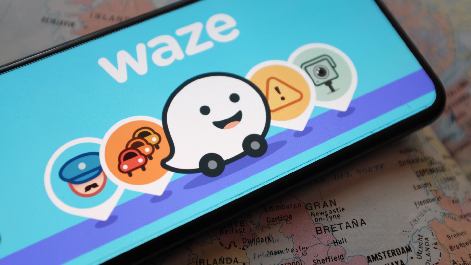 A smartphone showing the Waze app and icons on the screen.