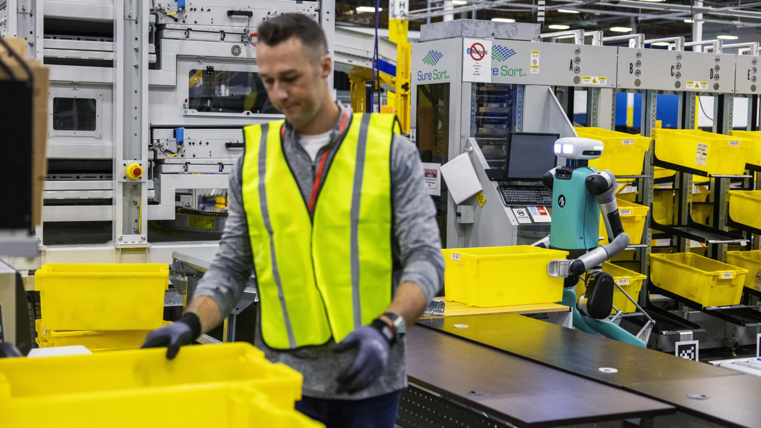 As Amazon's robot ranks swell, workers worry about their future