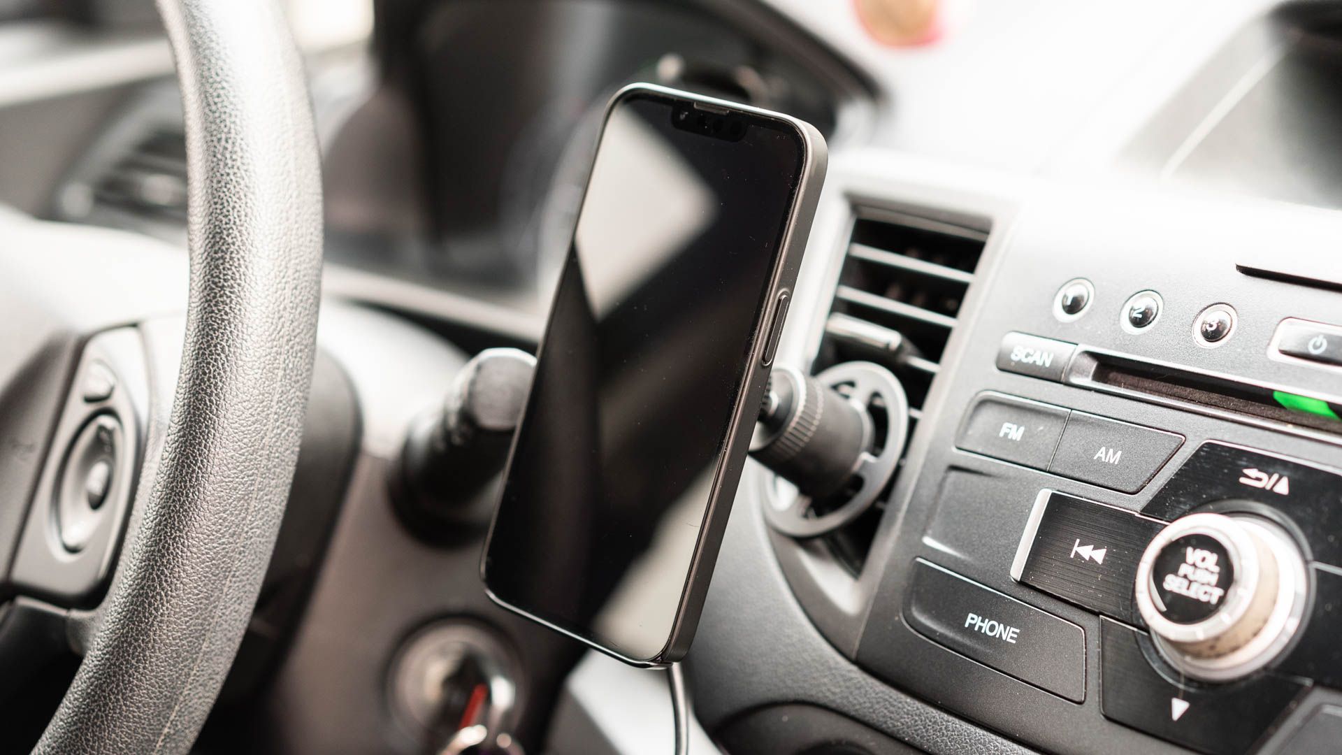 An iPhone on the Mophie Wireless Charging Vent Mount With MagSafe.