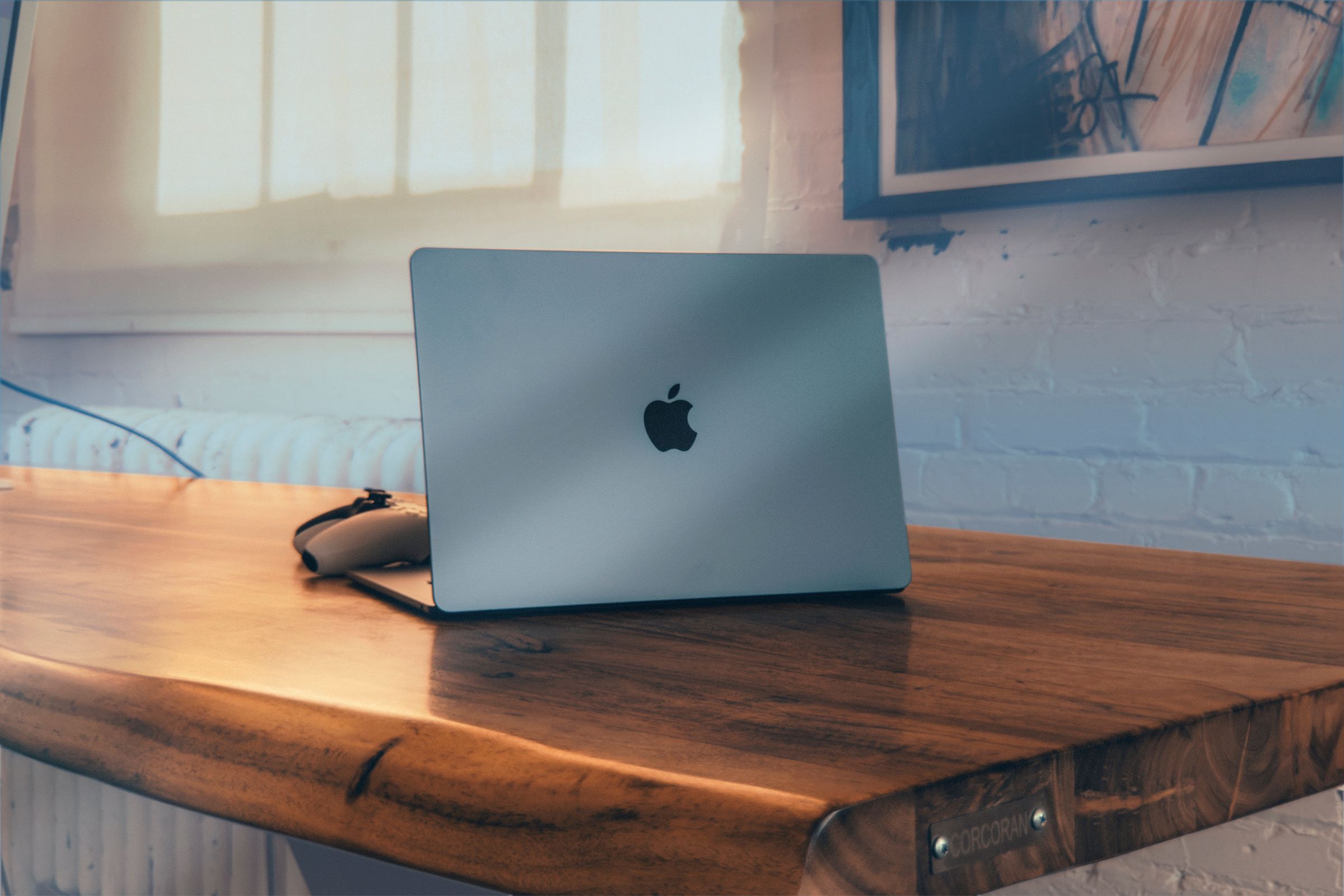 A MacBook air under a wooden table.