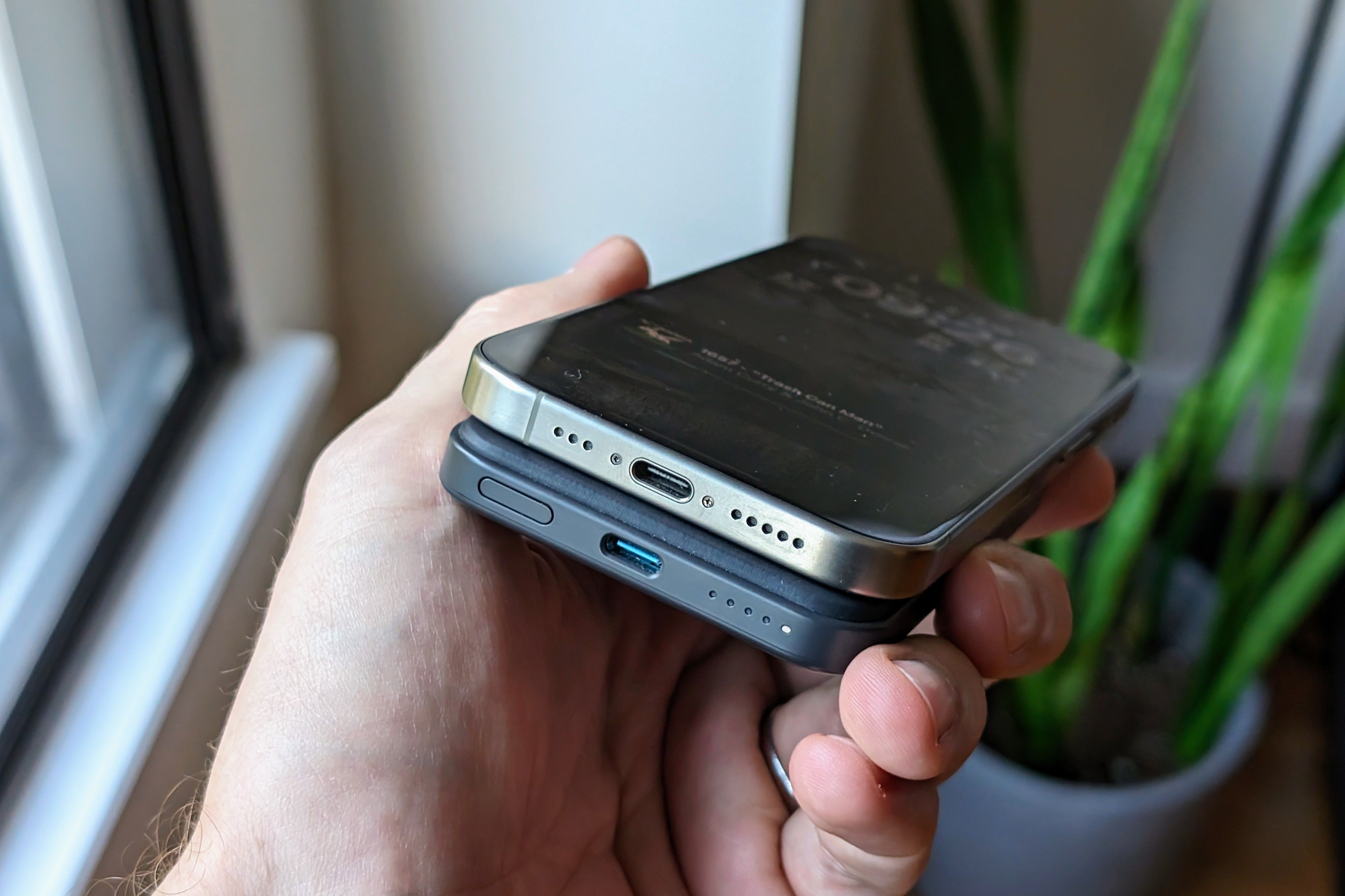 An Anker MagSafe battery on the back of an iPhone 15 Pro.