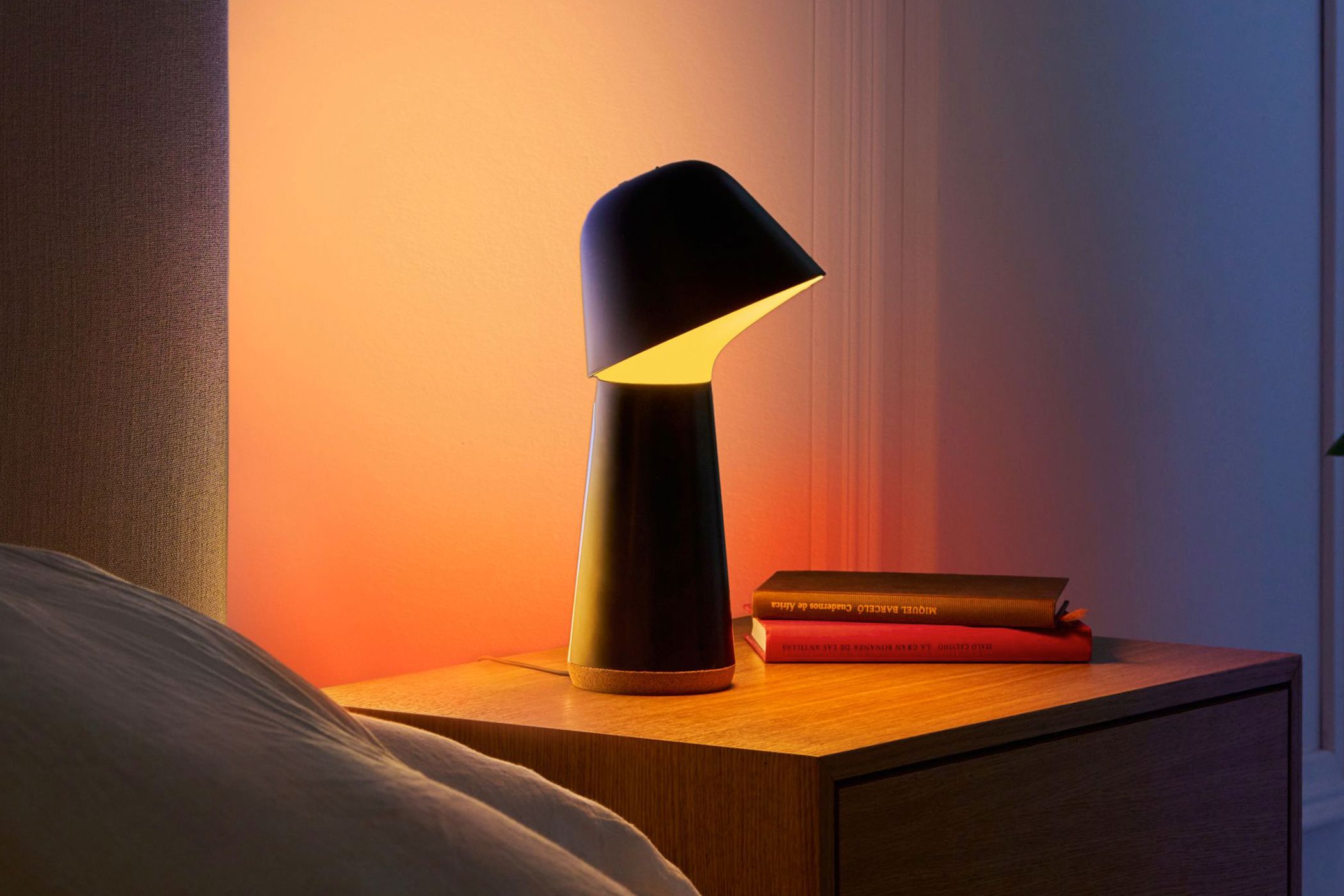 The Philips Hue Twilight lamp on a bedside table.