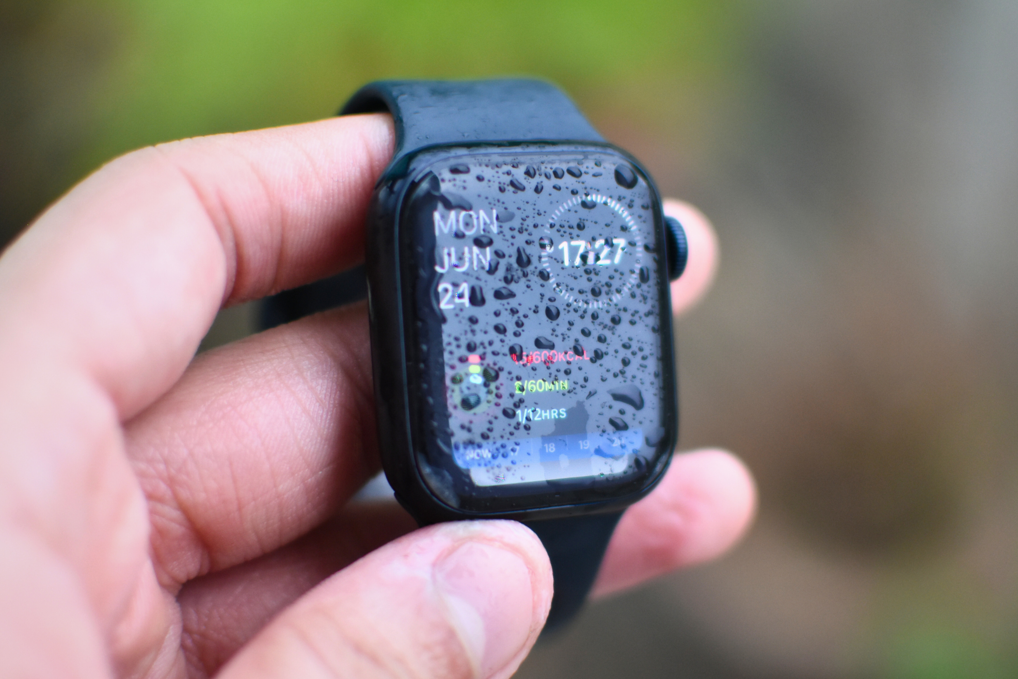 Apple Watch Series 8 with water droplets all over the screen.