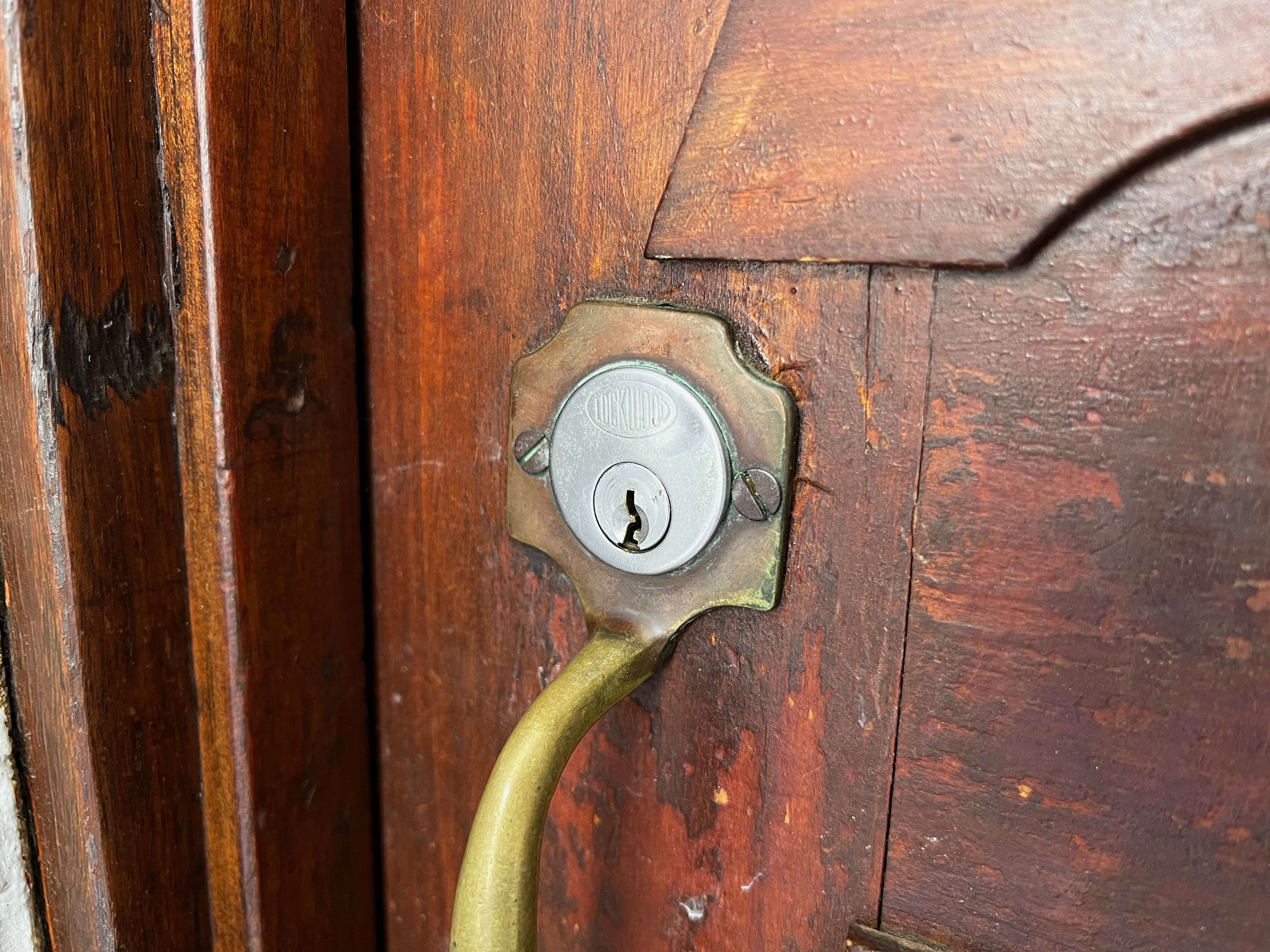 A traditional keyhole lock on a wooden door.