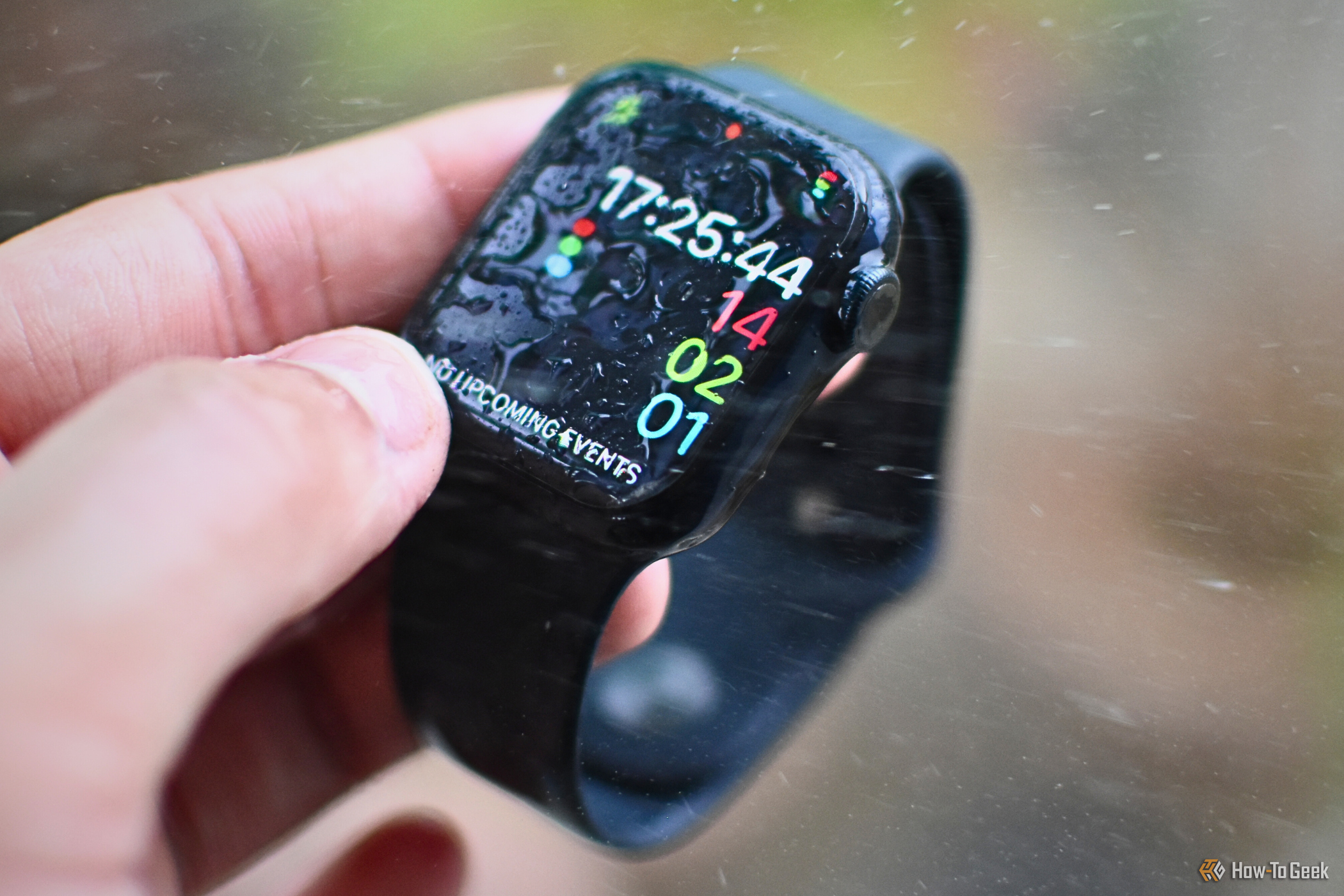 Apple Watch with water dropletes on the screen and in the background.