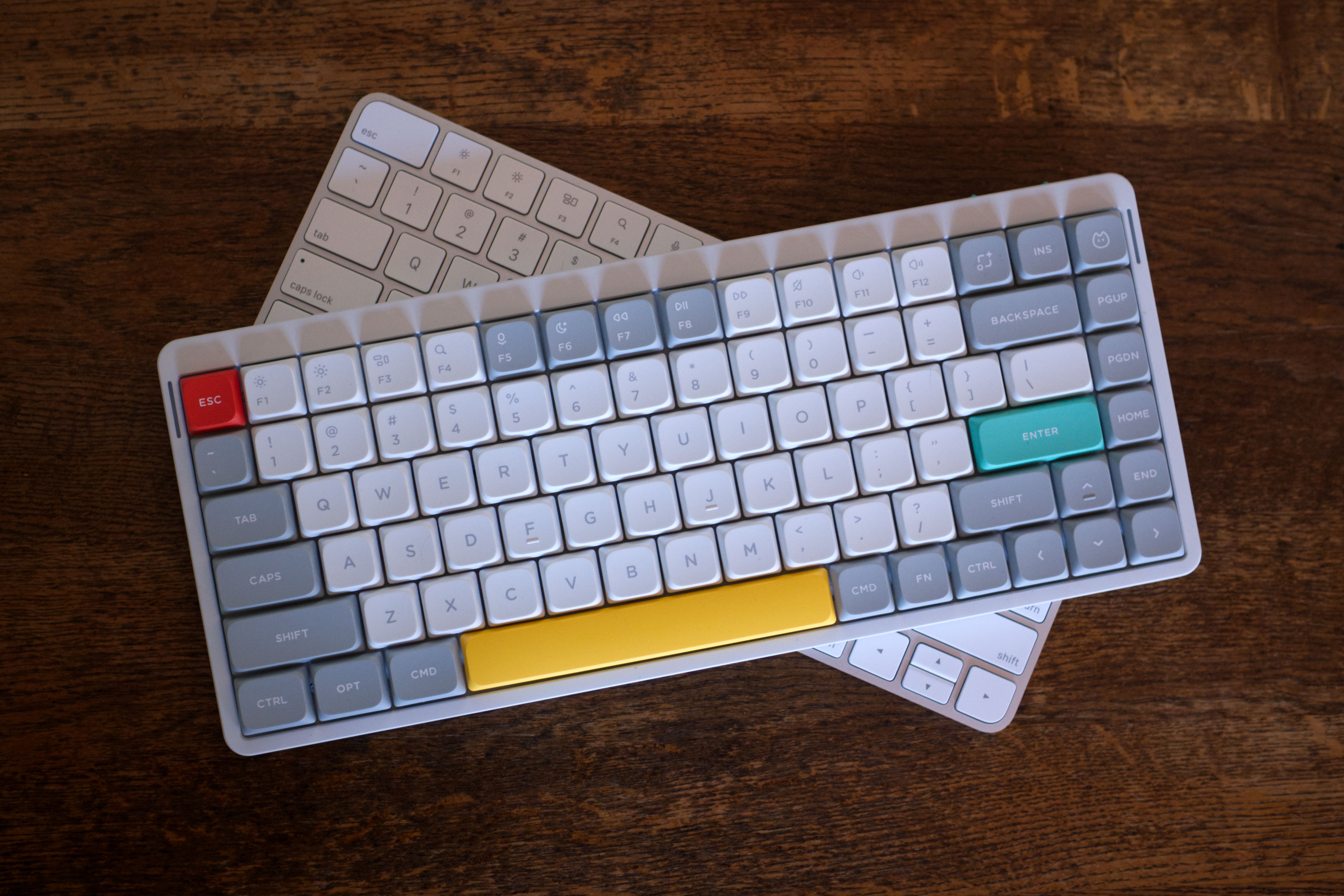 NuPhy Air75 V2 mechanical keyboard on top of Apple Magic Keyboard.