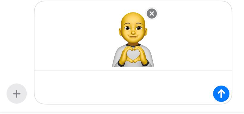 A Memoji making a heart with his hands