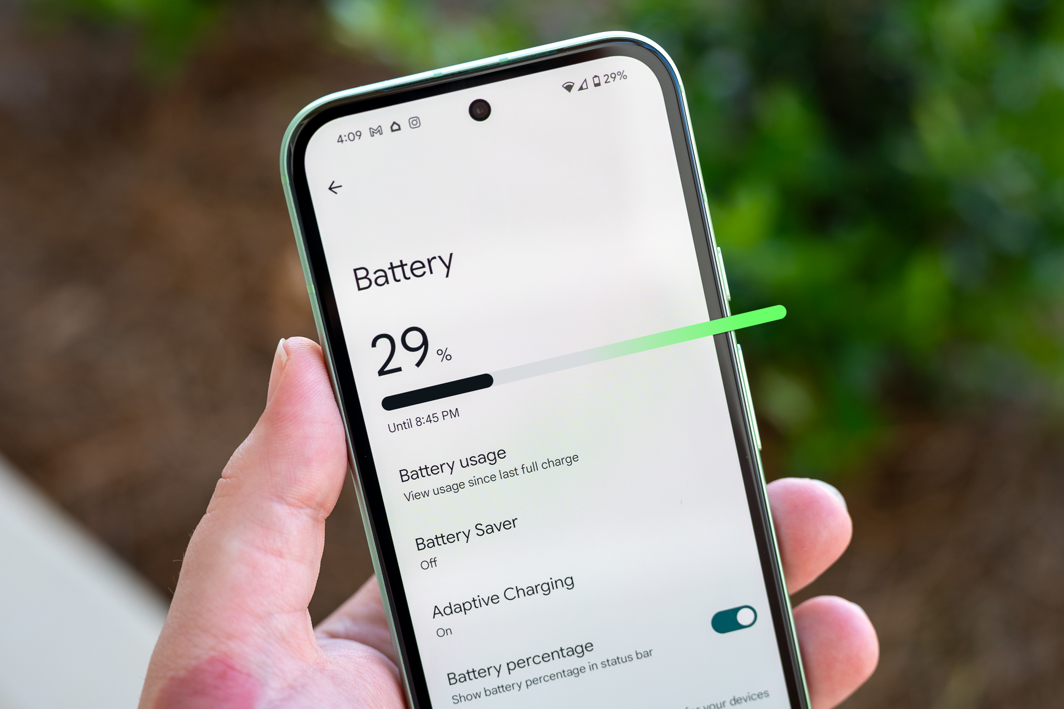 Person holding the Google Pixel 8a showing the Battery menu