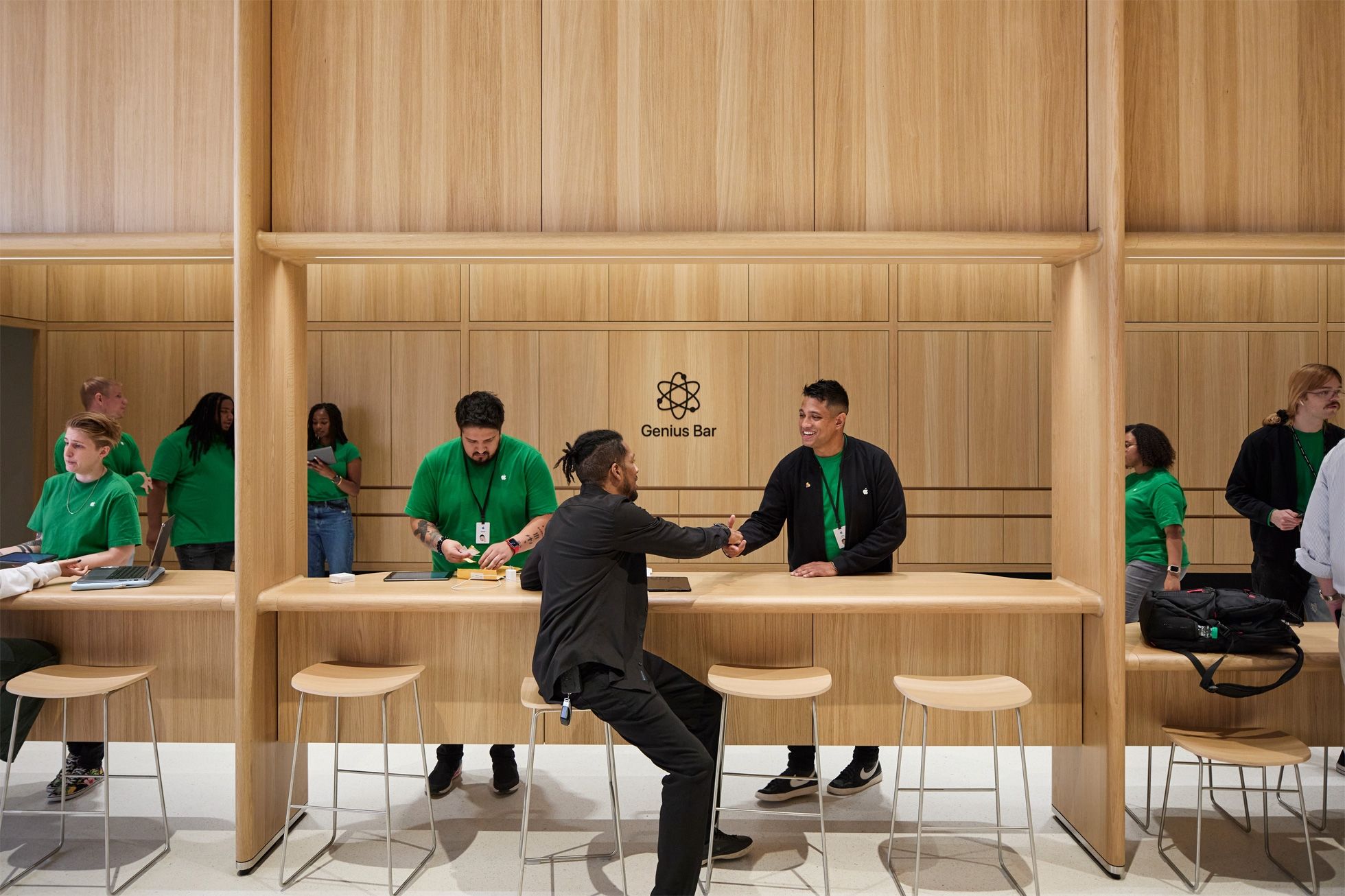 A technician greeting a customer at the Genius Bar in Apple's Tysons Corner retail store in Virginia, United States.