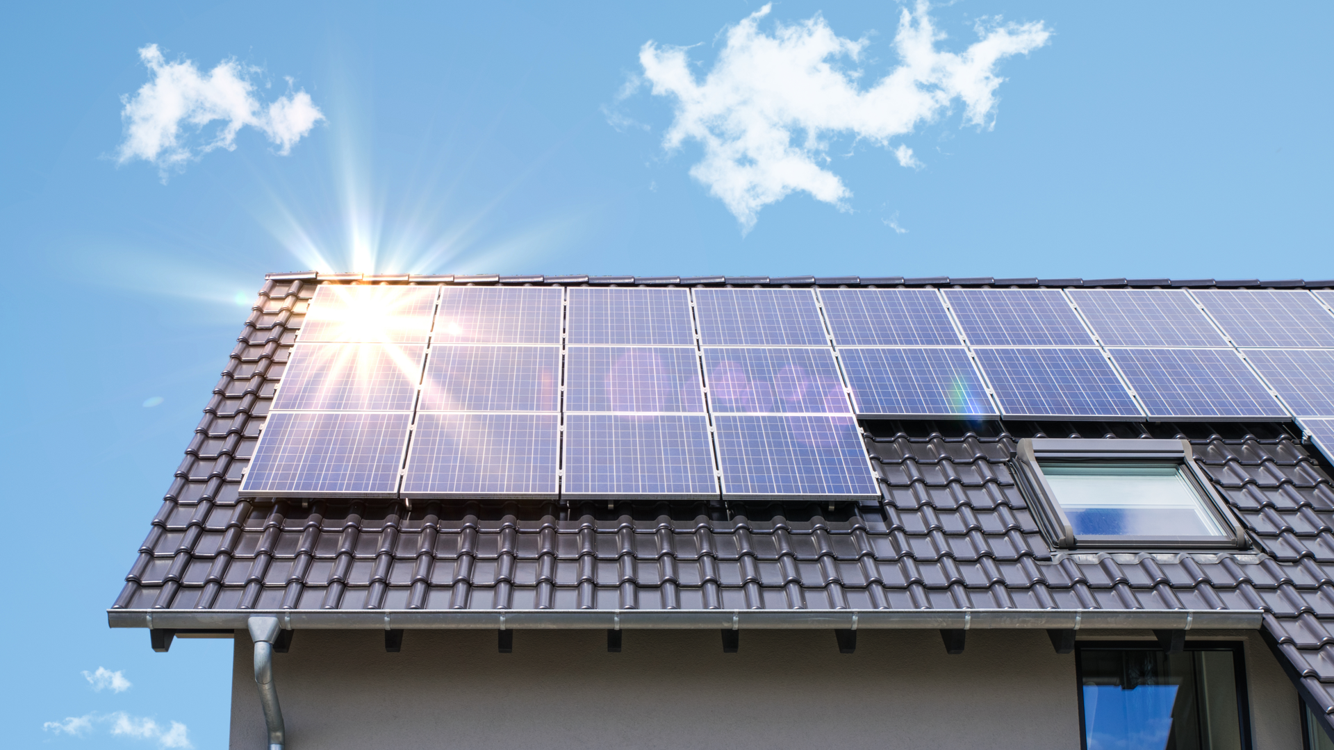 Solar panels on a roof reflecting sunlight.