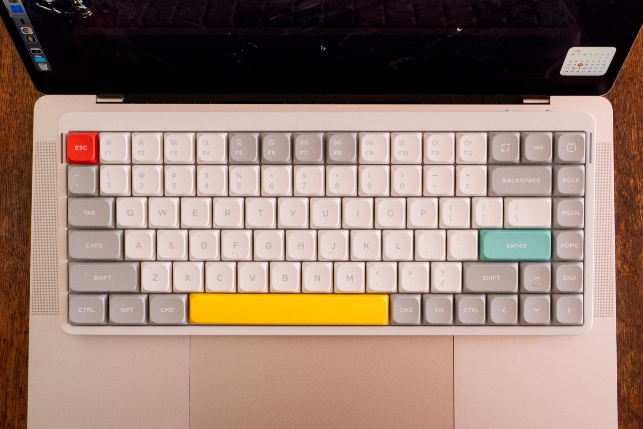 A NuPhy Air75 V2 keyboard overlaid on a MacBook Pro.