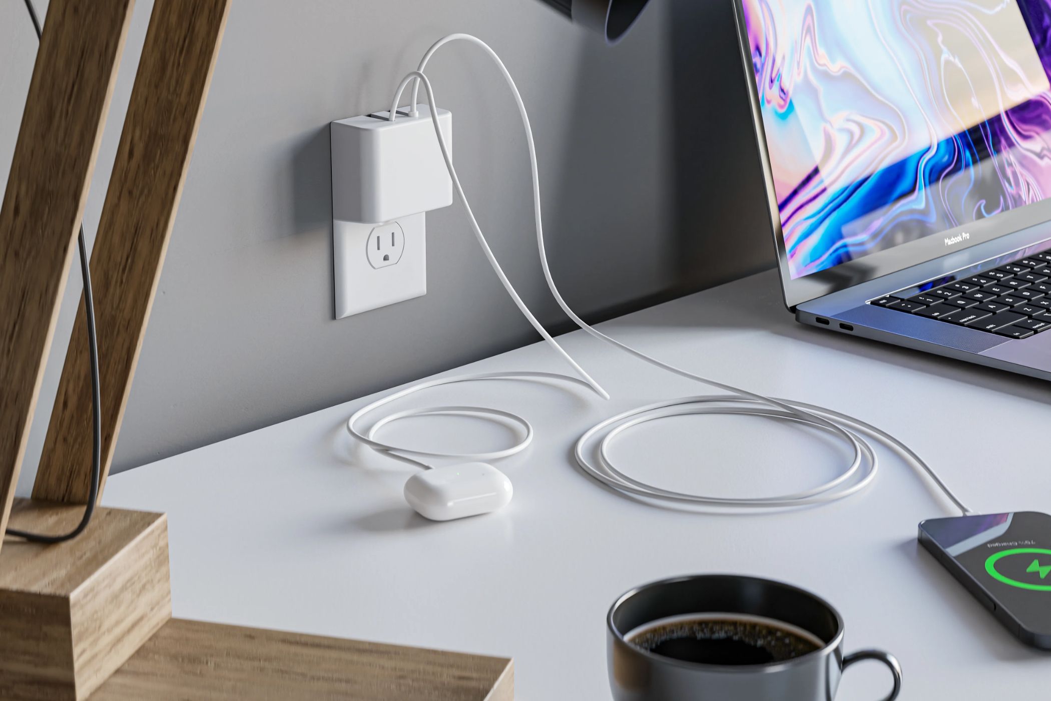 Permaplug wall charger next to a laptop and phone.