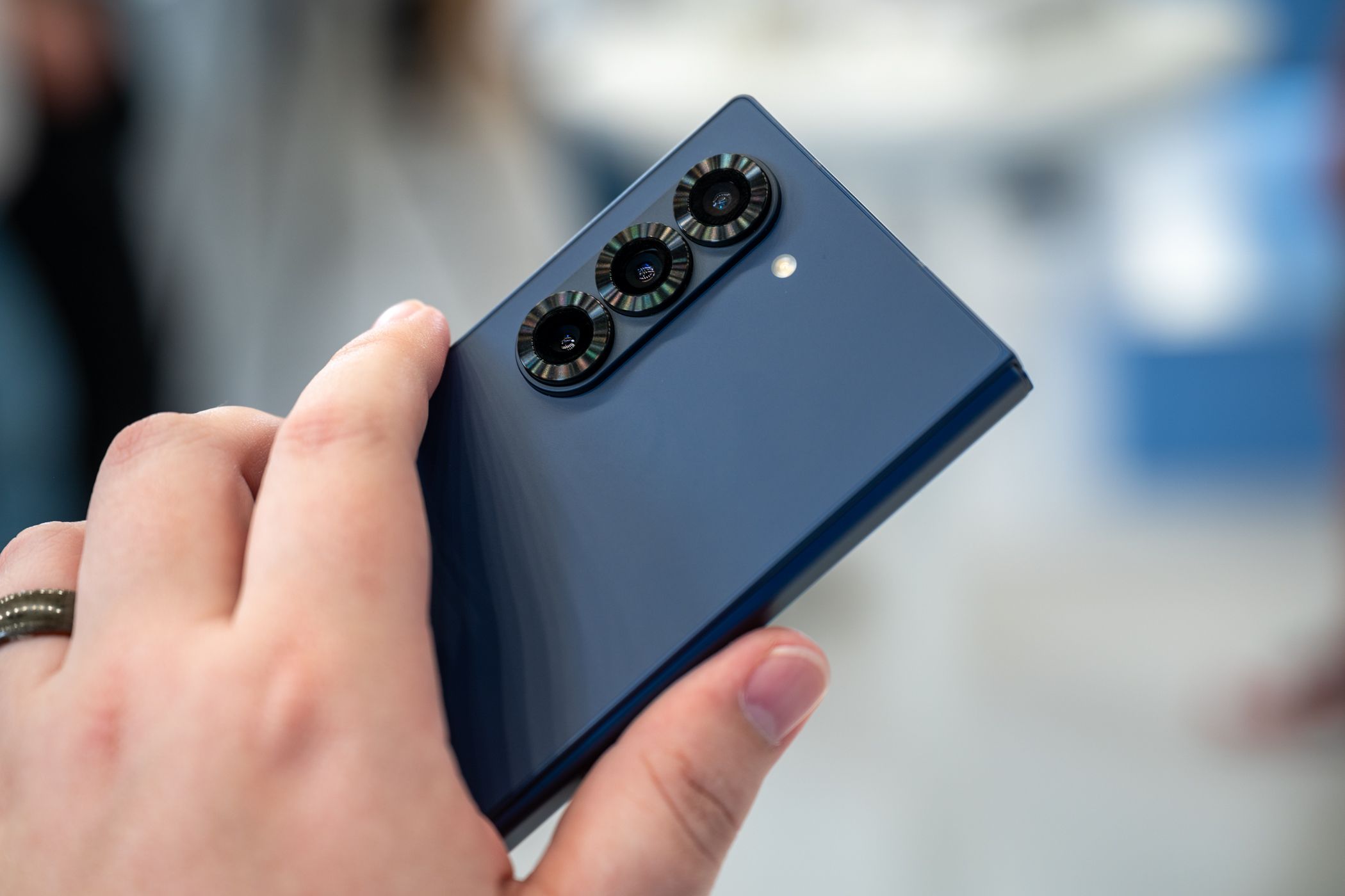 person holding the samsung galaxy z fold 6 showing the three rear cameras