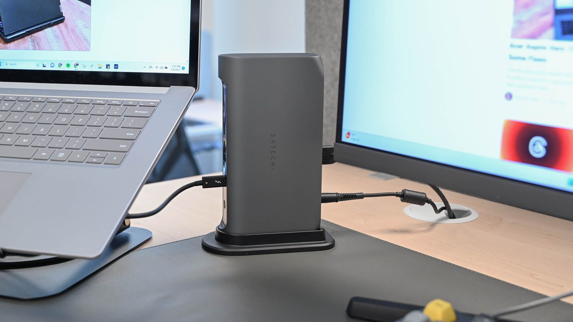 A desk set up with a laptop and monitor plugged into the Satechi Thunderbolt 4 Multimedia Pro Dock.