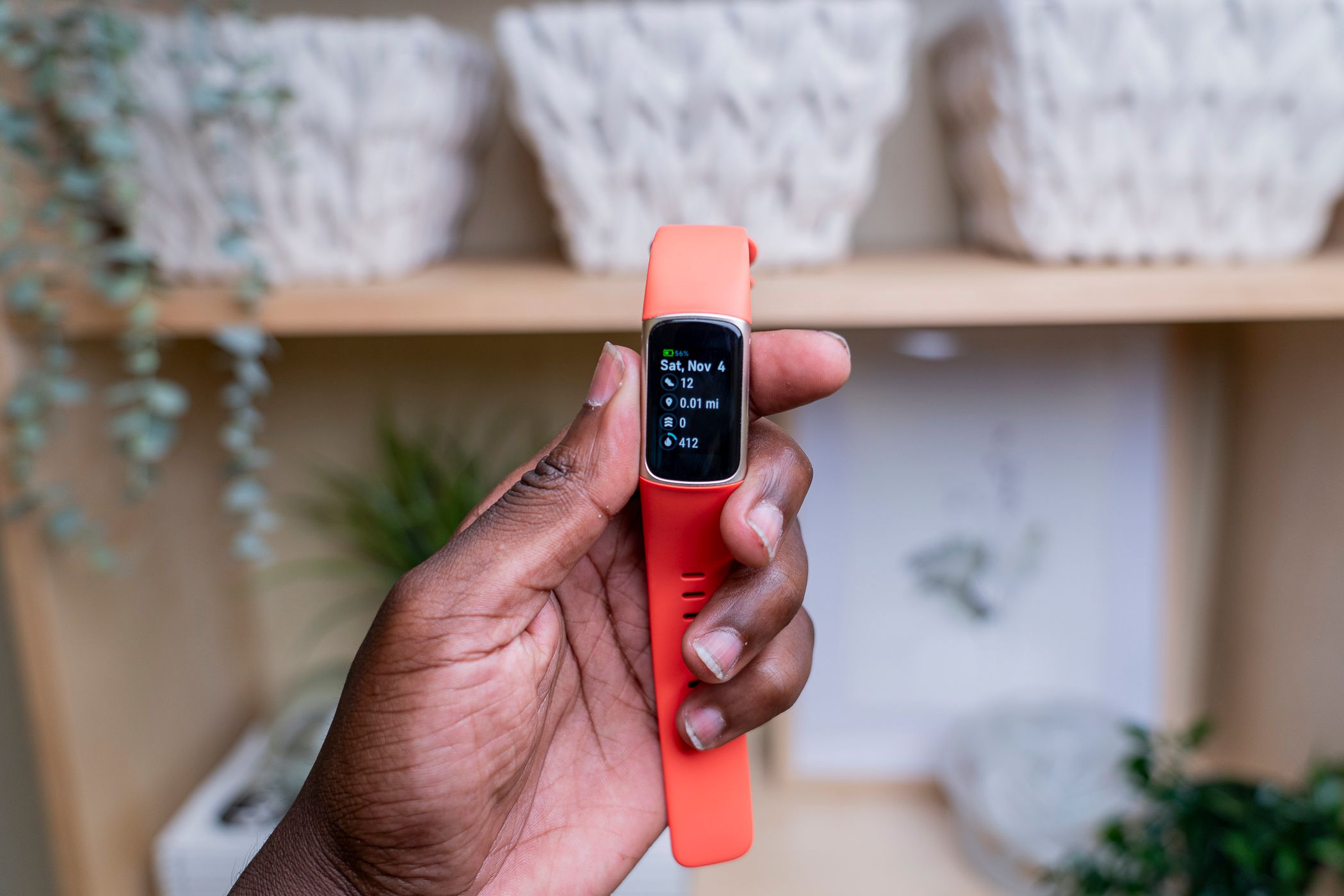 A Fitbit watch being held