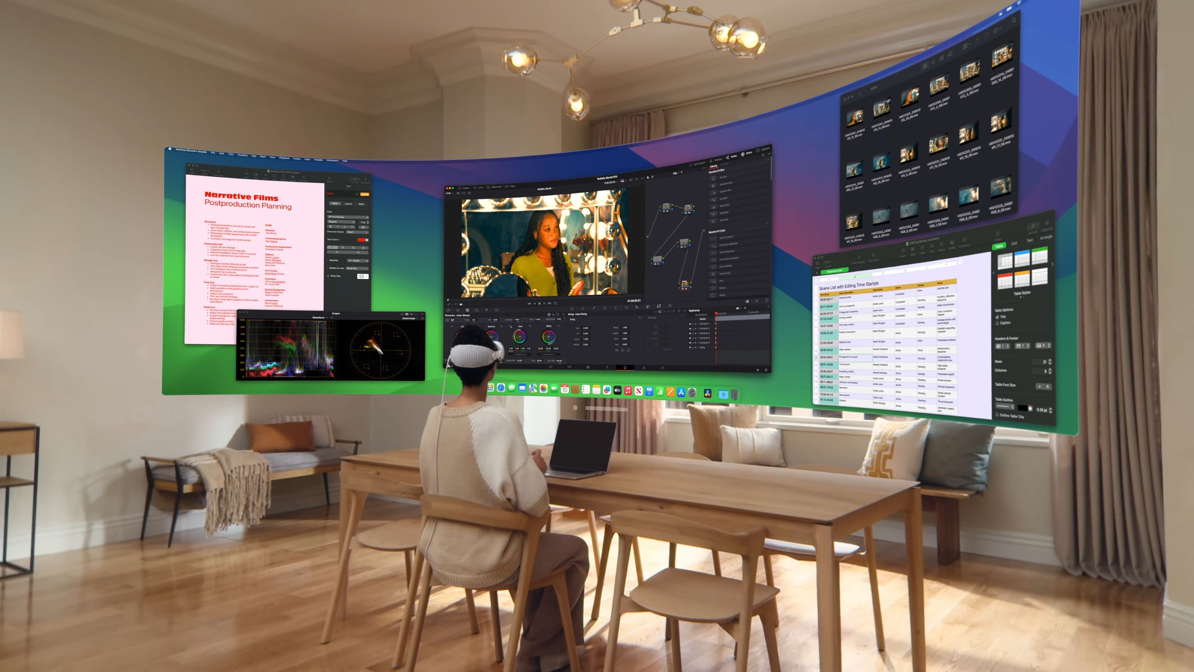 A woman sitting at a wooden desk in a stylish apartment, wearing a Vision Pro headset and using panoramic virtual Mac displays.