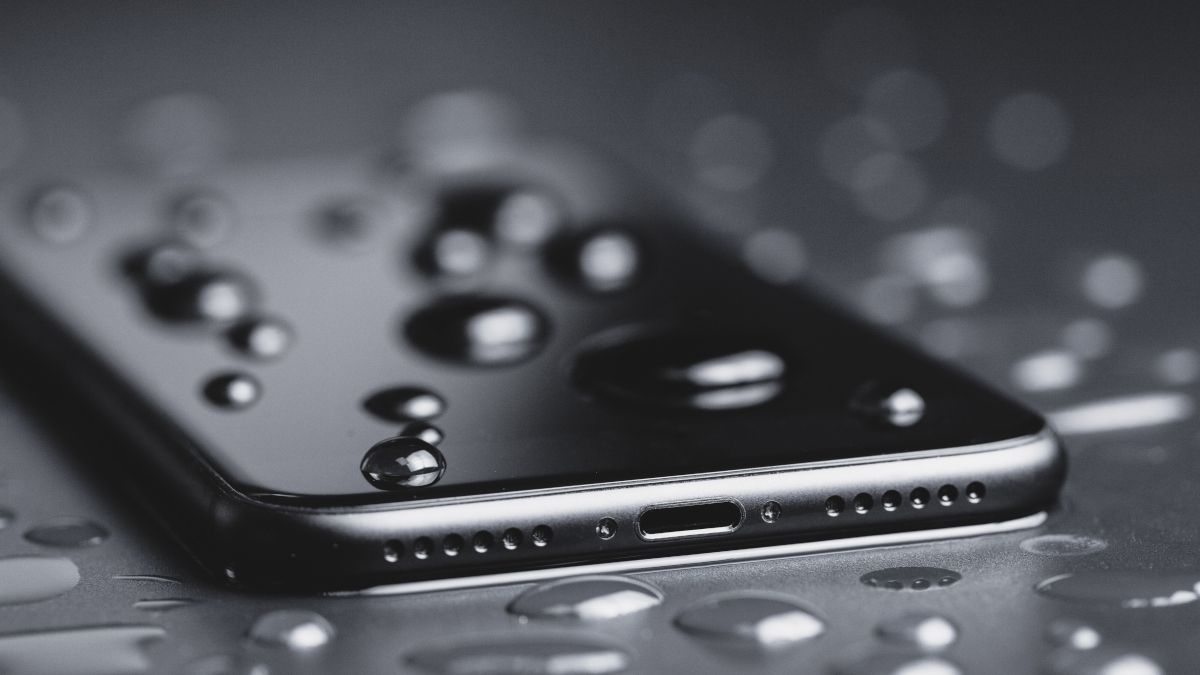 Closeup of a smartphone with water droplets on it.