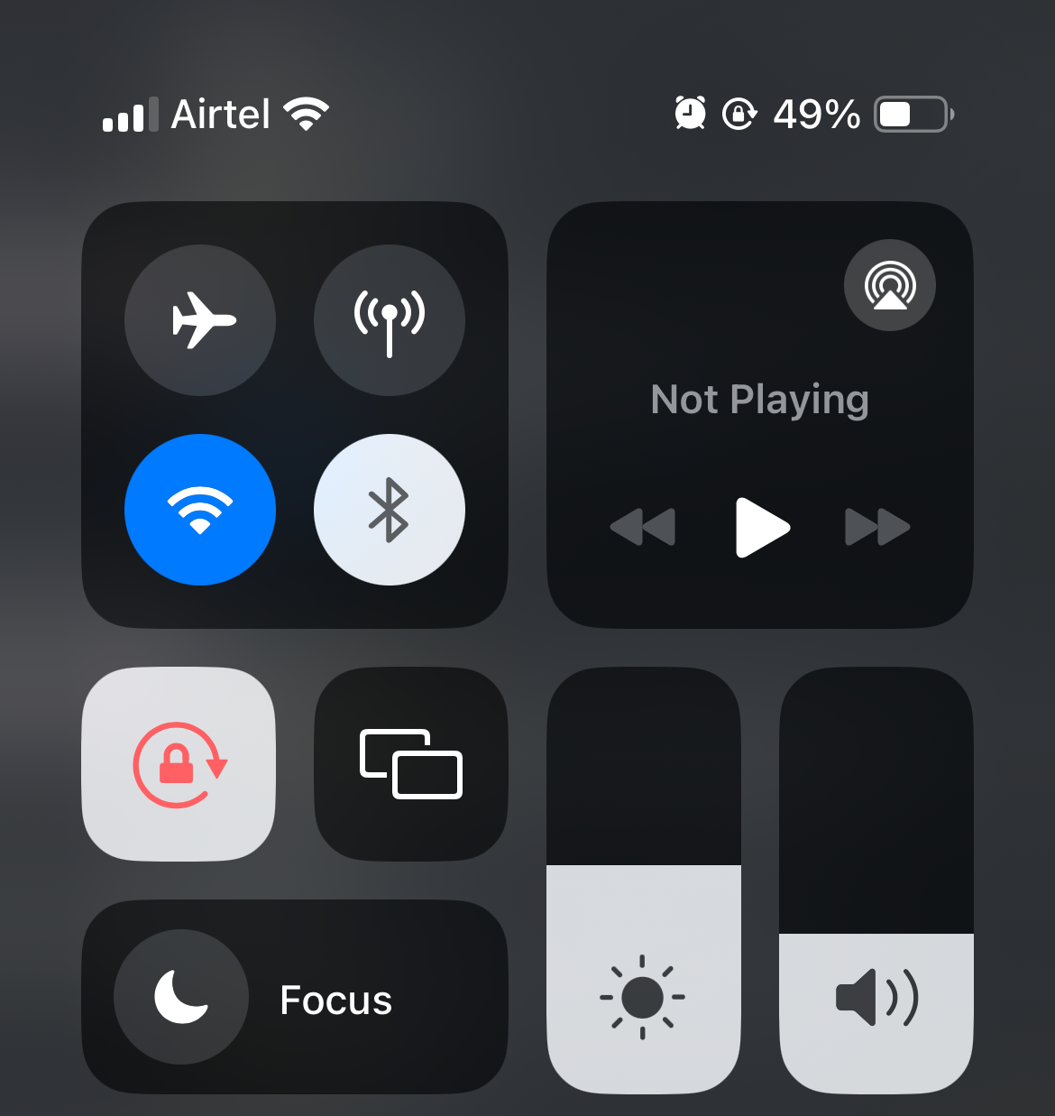 iPhone control center with Wi-Fi on and Bluetooth off.