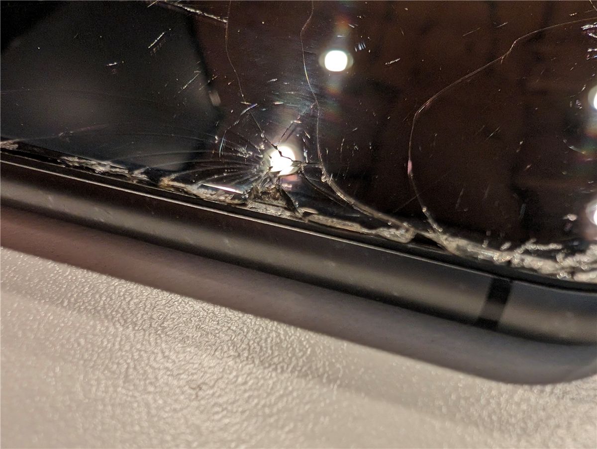 An iPhone with a badly cracked screen.