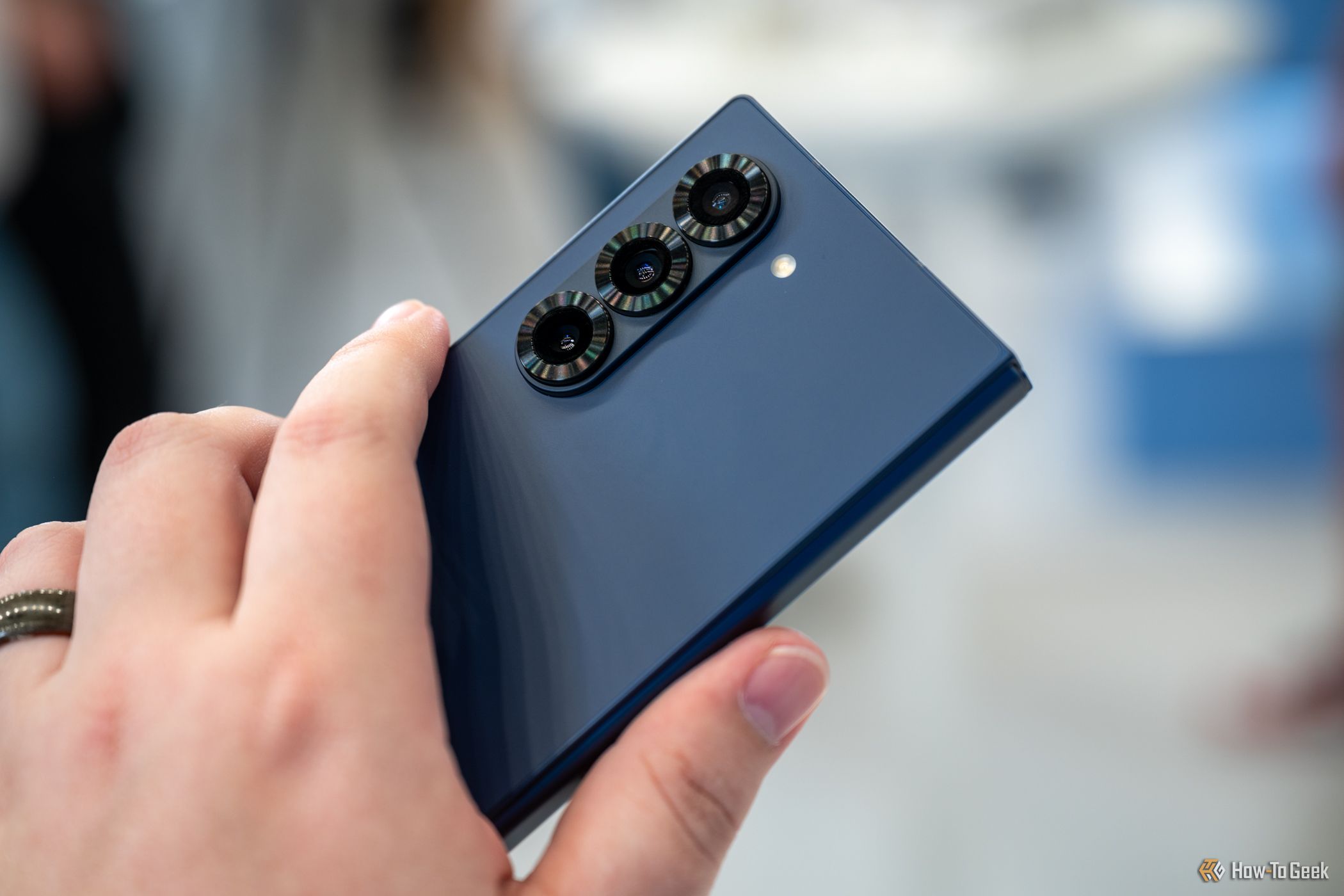 Person holding the Samsung Galaxy Z Fold 6 showing the three rear cameras