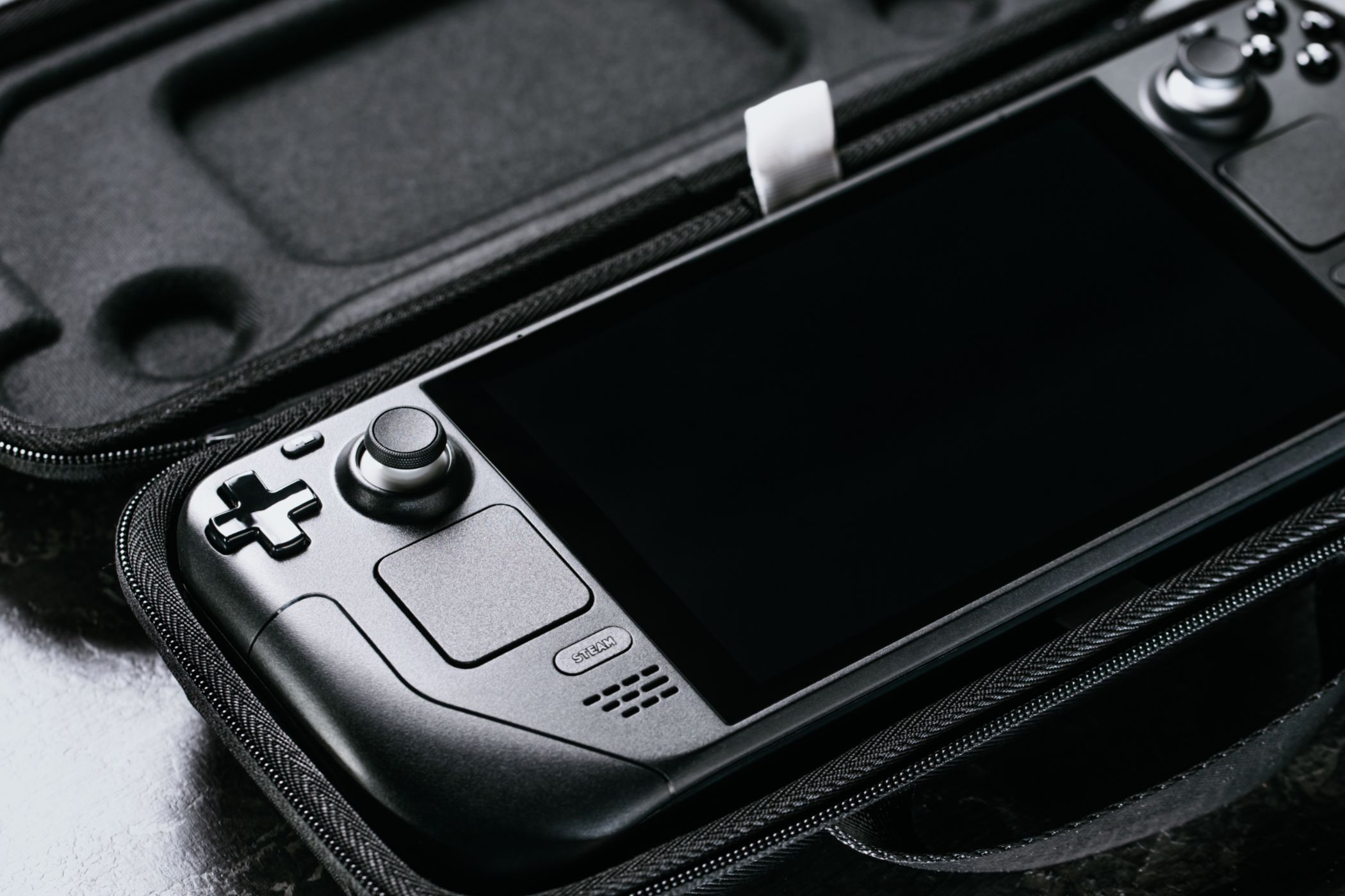 Valve Steam Deck handheld gaming PC in a protective case.