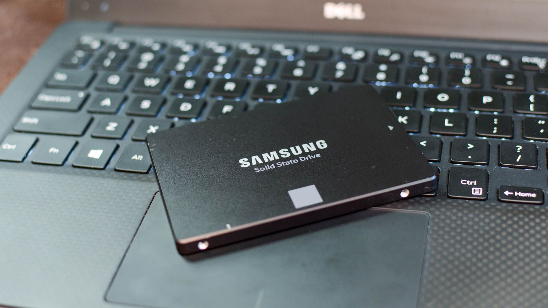 An SSD placed on top of a laptop keyboard.