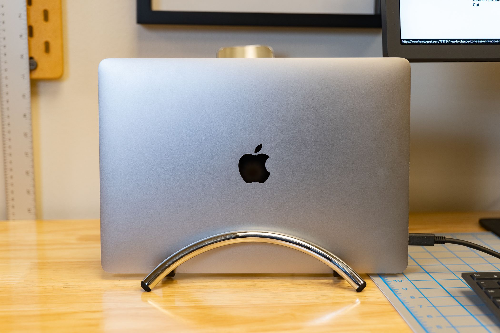 A MacBook sitting upright on a desk.