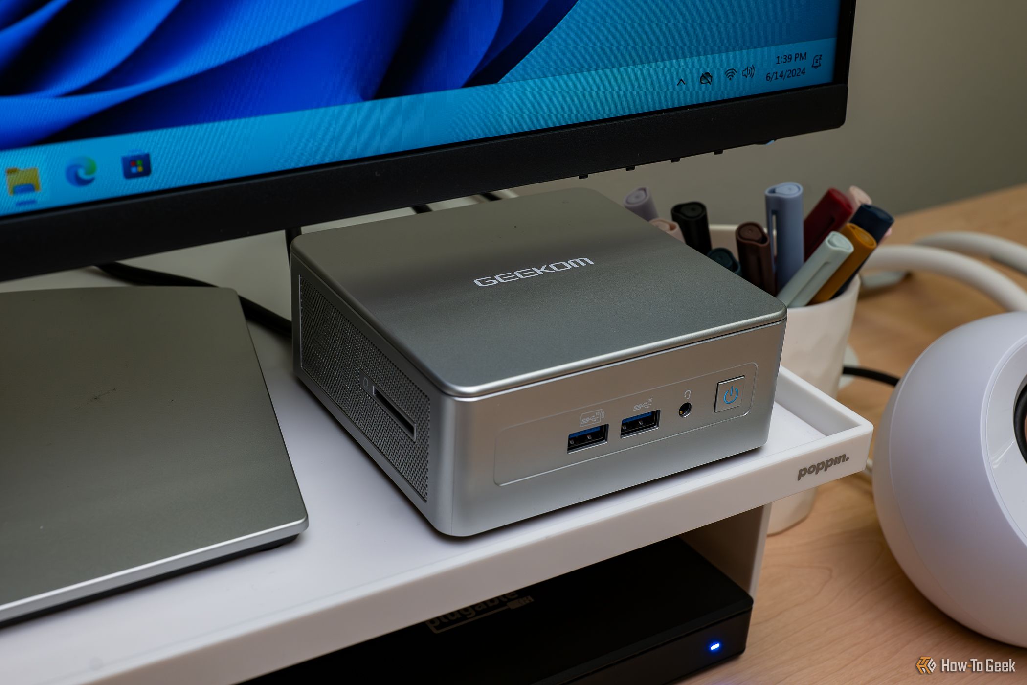 GEEKOM AE7 Mini PC on display, desktop organization