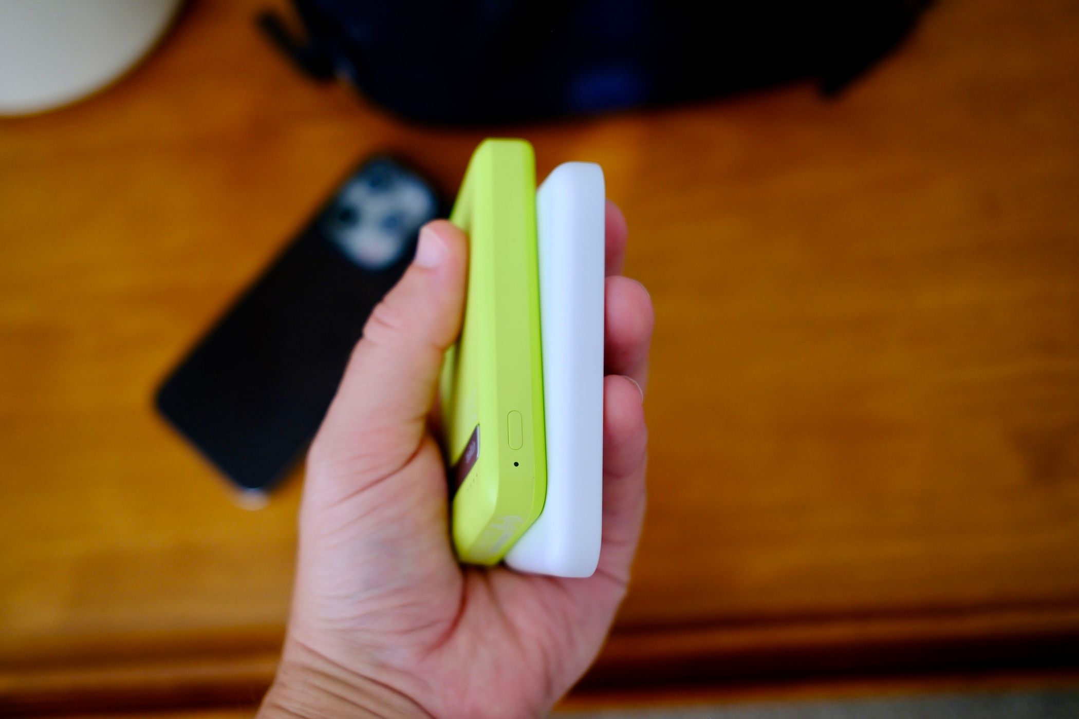 Person holding two iPhone MagSafe Powerbanks.