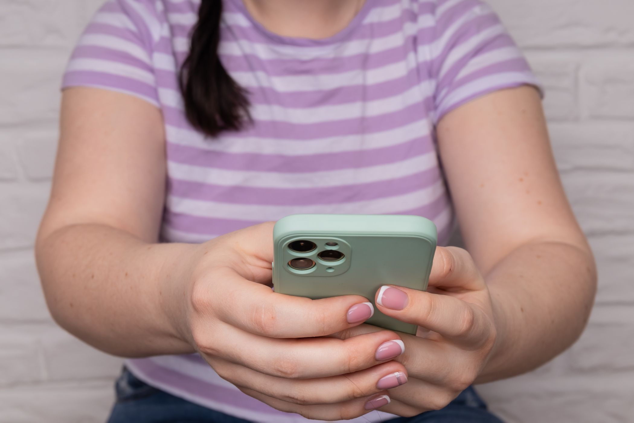 A child holding an iPhone 14 Pro.