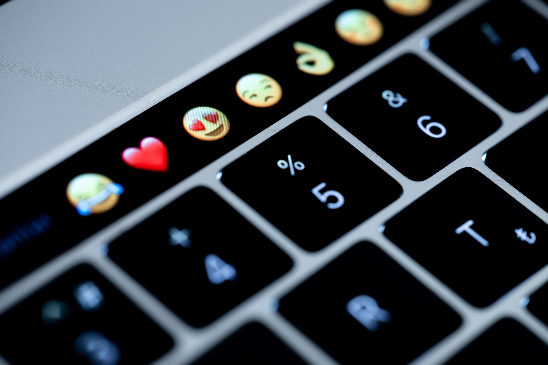 A row of emojis on a MacBook Pro Touch Bar.