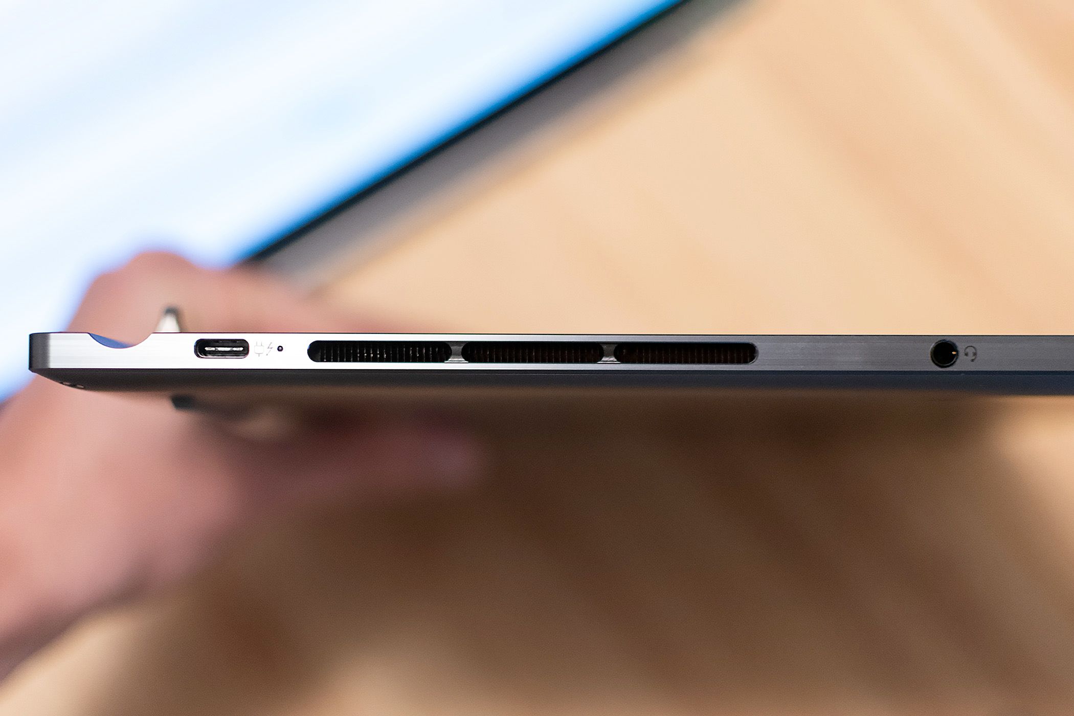 A Thunderbolt 4 port and headphone jack on the side of the ThinkBook Plus Gen 5 Hybrid laptop.