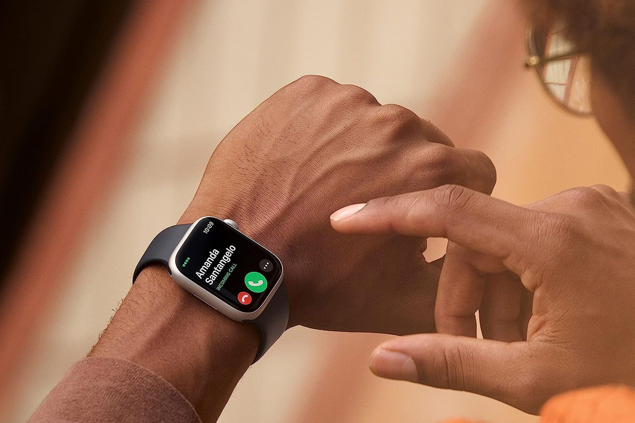 Incoming call on an Apple Watch Series 8 on a person's wrist.