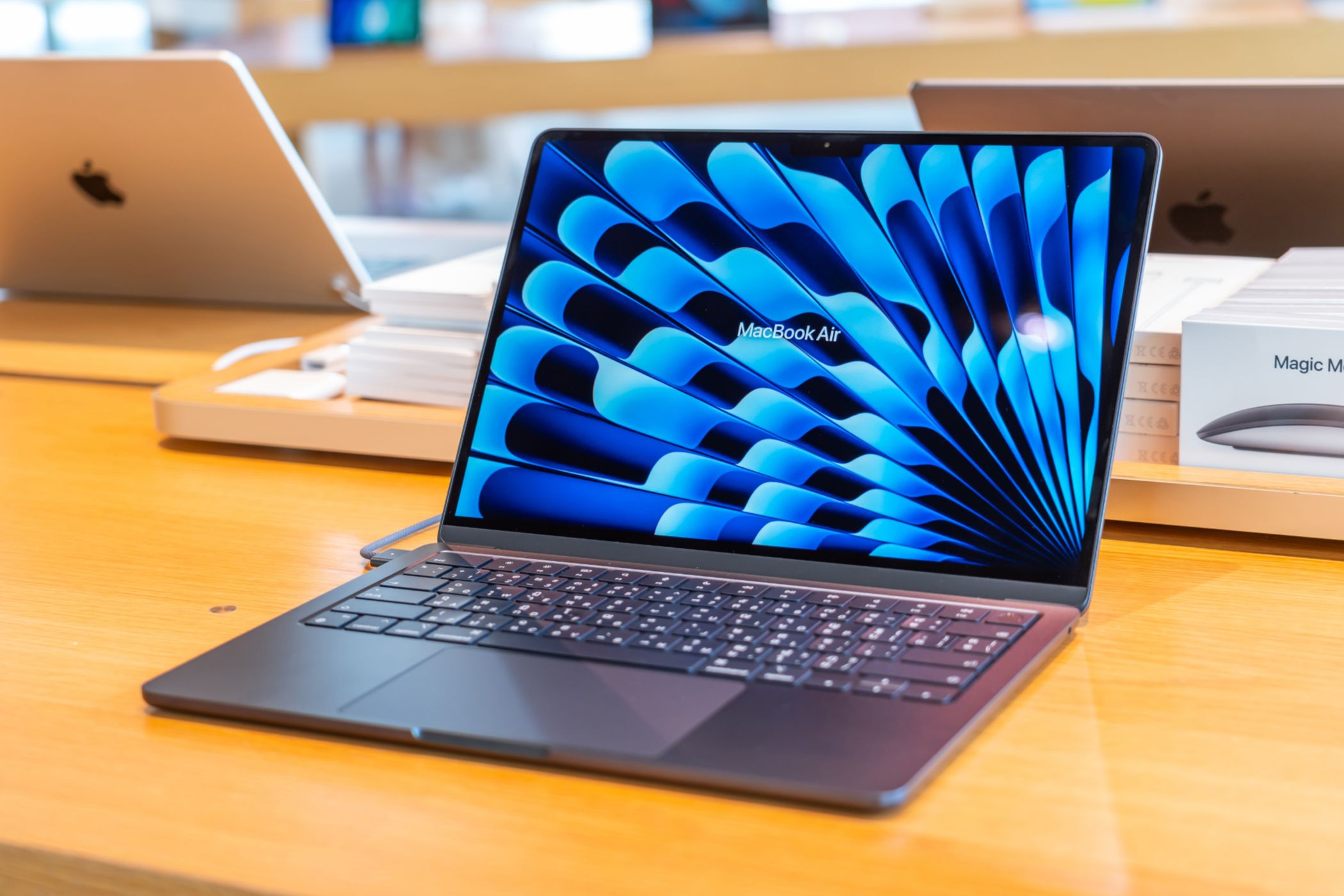 Dark color MacBook Air in an Apple Store.