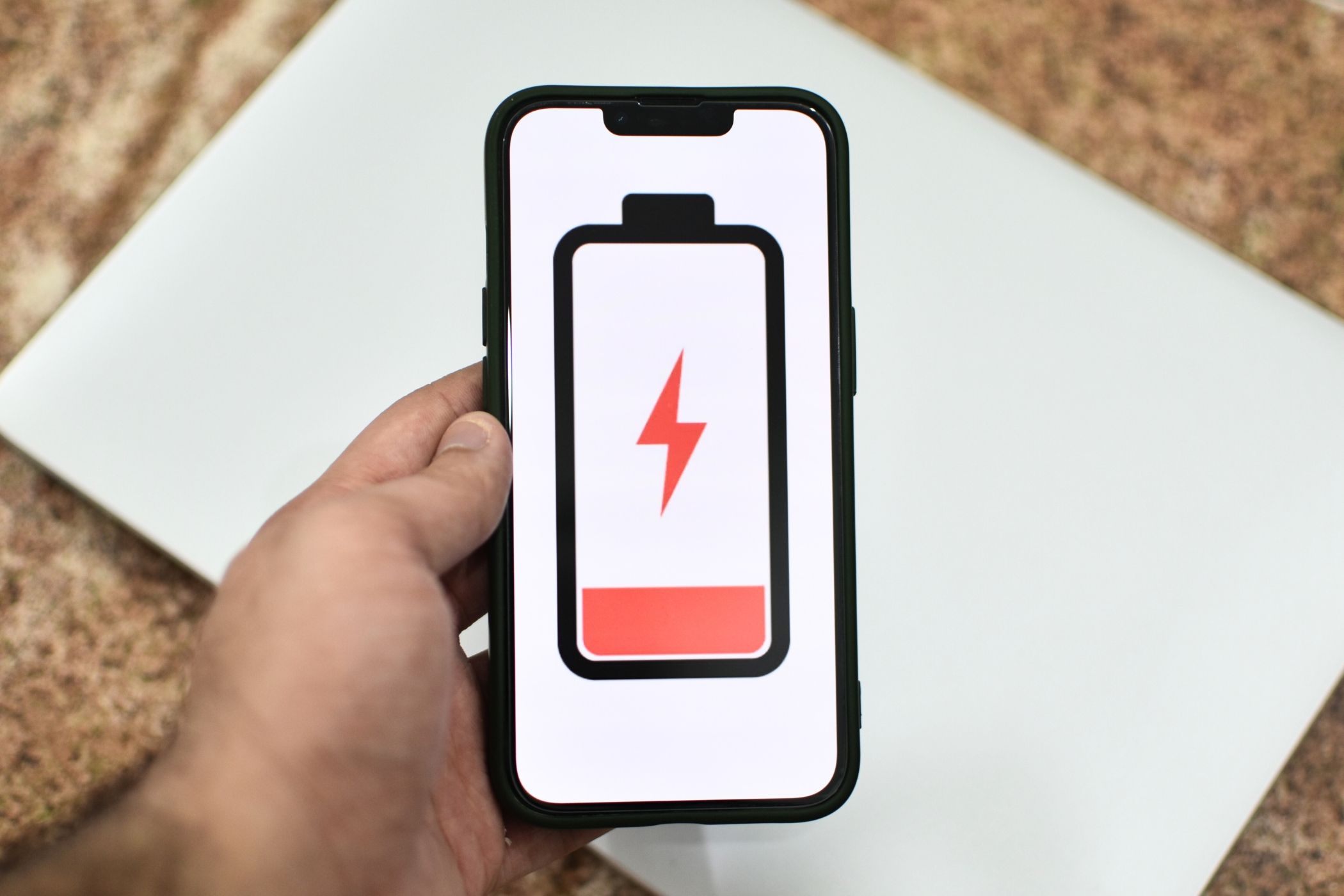 iPhone with illustration of an empty battery on the screen.