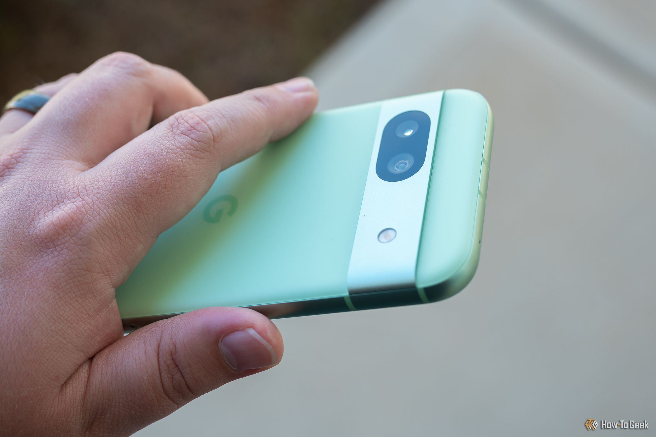 Person holding the Google Pixel 8a showing the rear camera bar