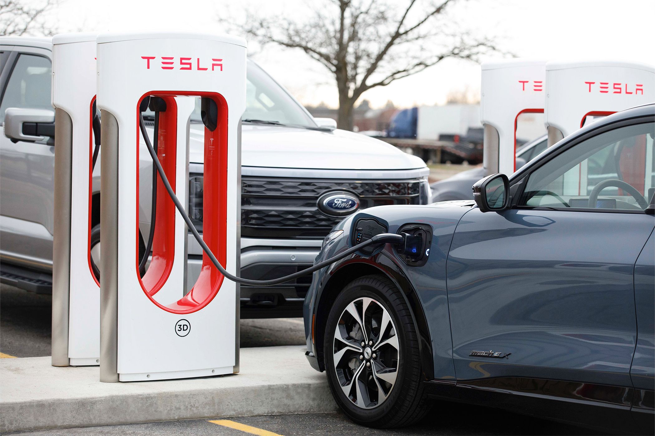 A Ford EV charging at a Tesla Supercharger.