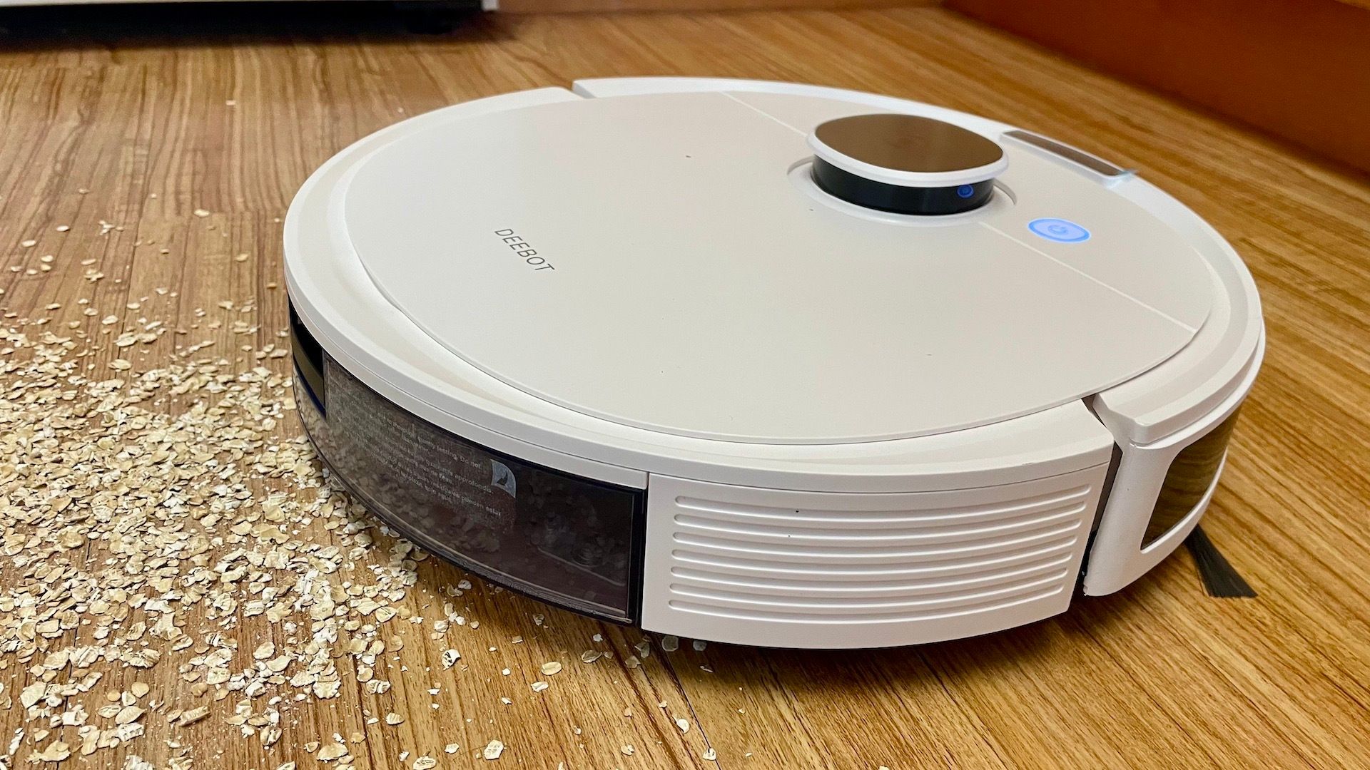 The Ecovacs Deebot N10 Plus cleaning oats off a kitchen floor