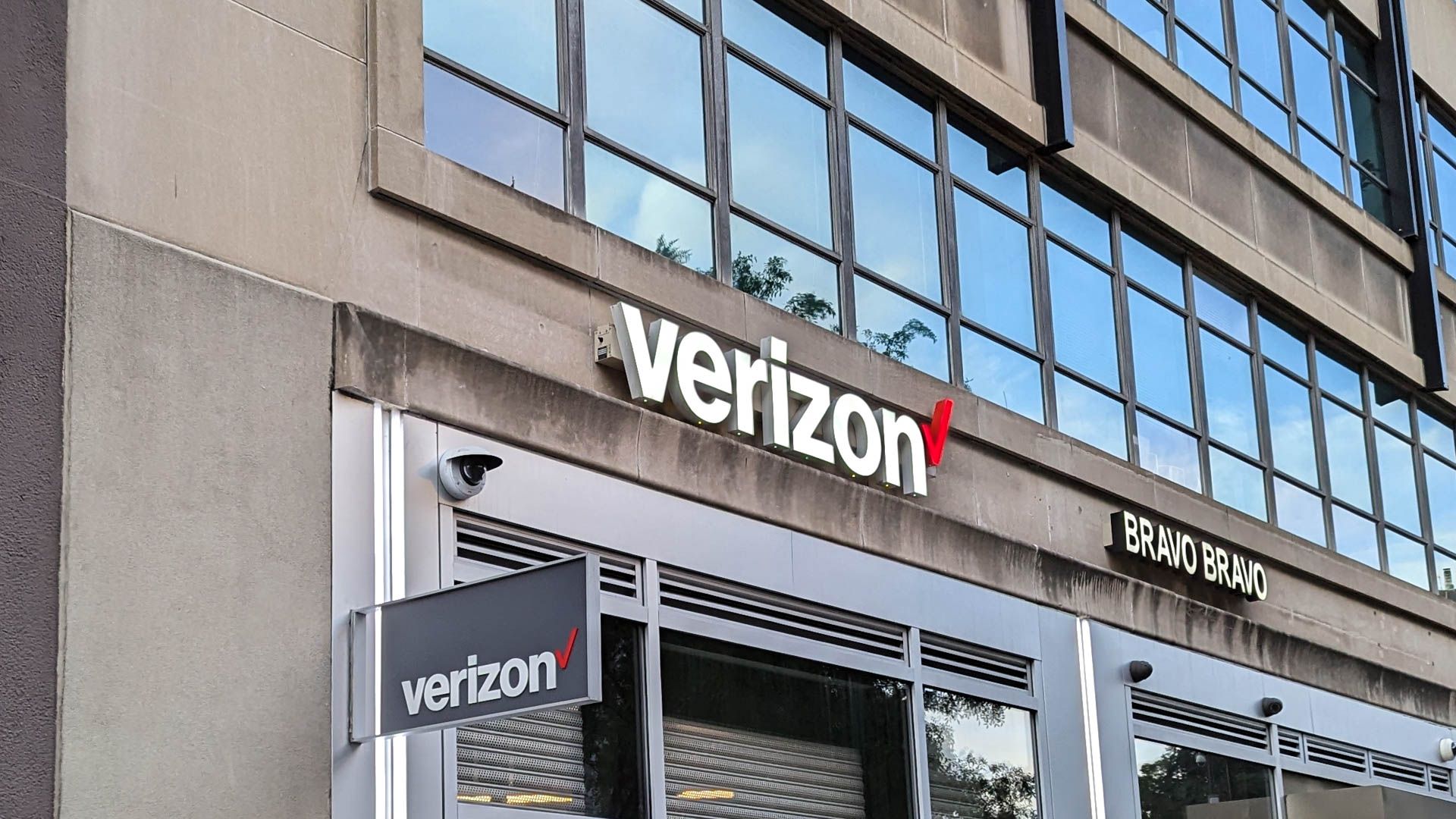 The front of a Verizon store in a city.