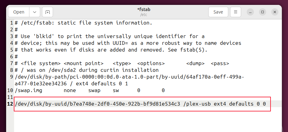 The /etc/fstab file in an editor, with the new line added and highlighted.