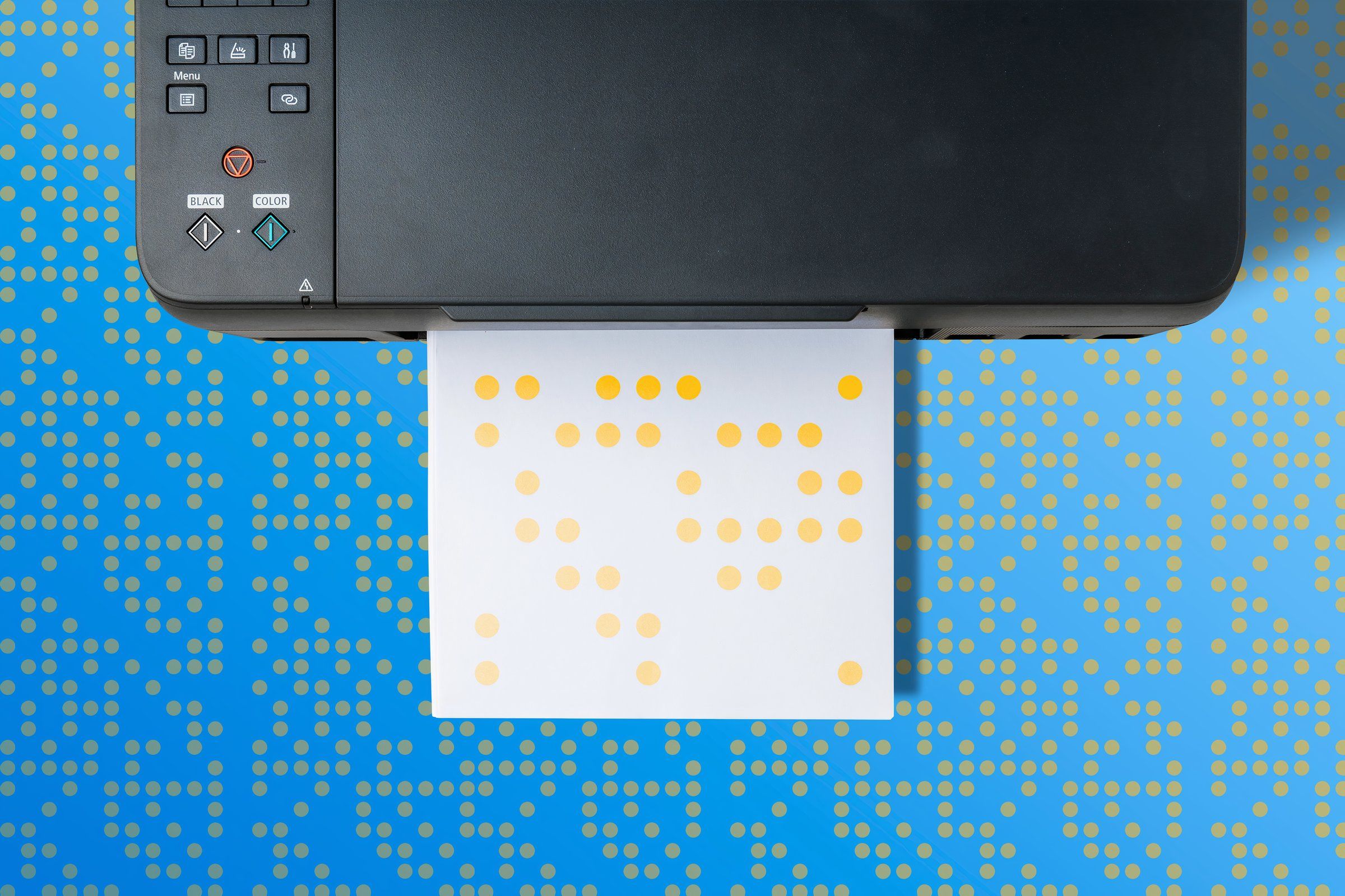 A paper coming out of a printer with some yellow dots.