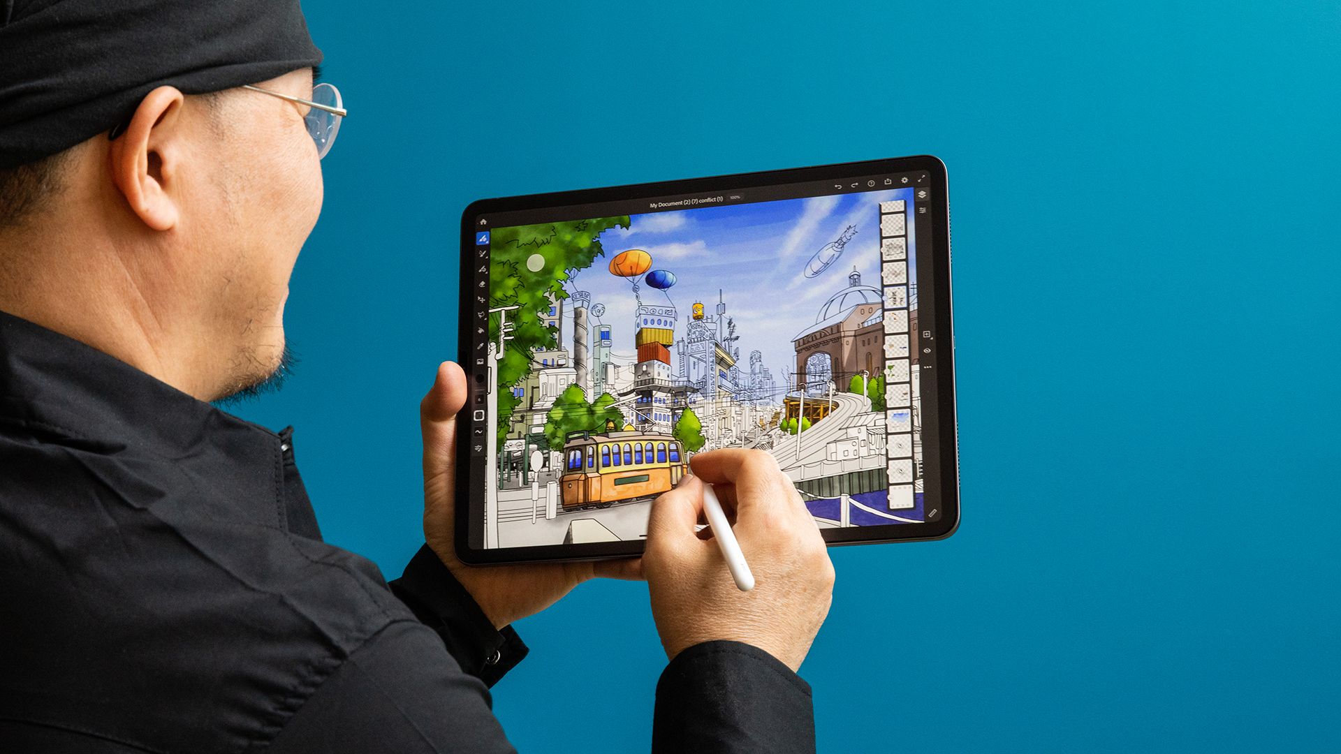 Man sketching an illustration in Adobe Fresco using his iPad with Apple Pencil.