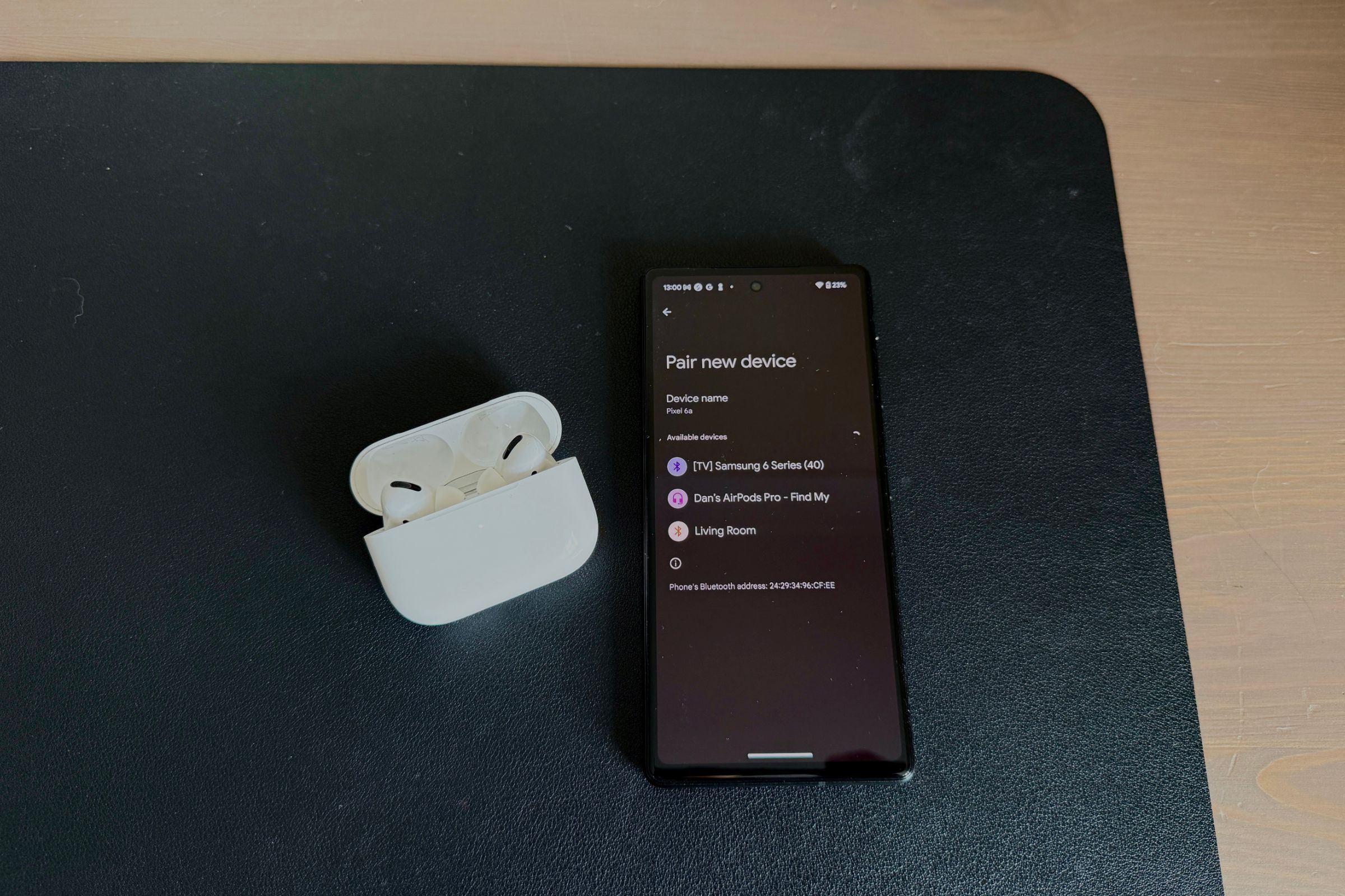 Google Pixel next to AirPods Pro in pairing mode.