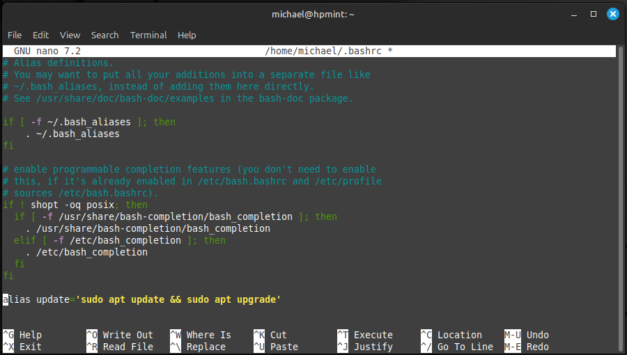 A terminal window displaying the nano text editor adding an apt update alias to the bottom of the .bashrc file