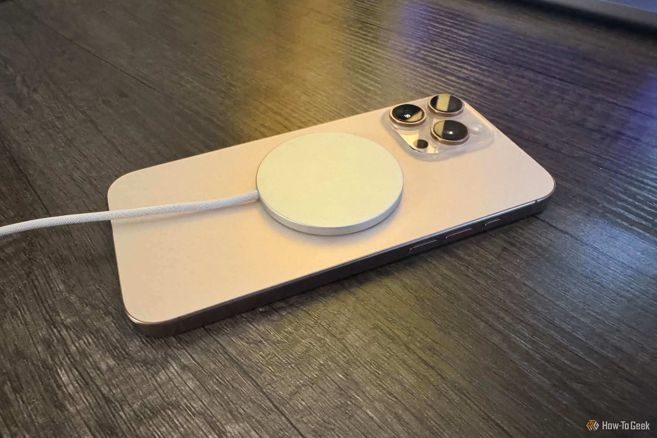 Apple MagSafe Charger attached to iPhone 16 Pro Max from an angle