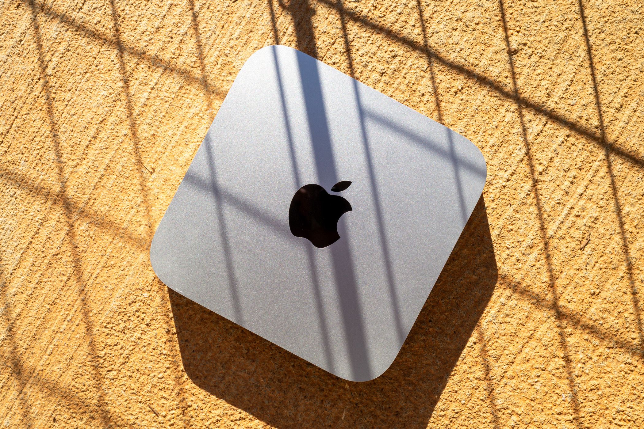 A Mac Mini on a concrete surface.