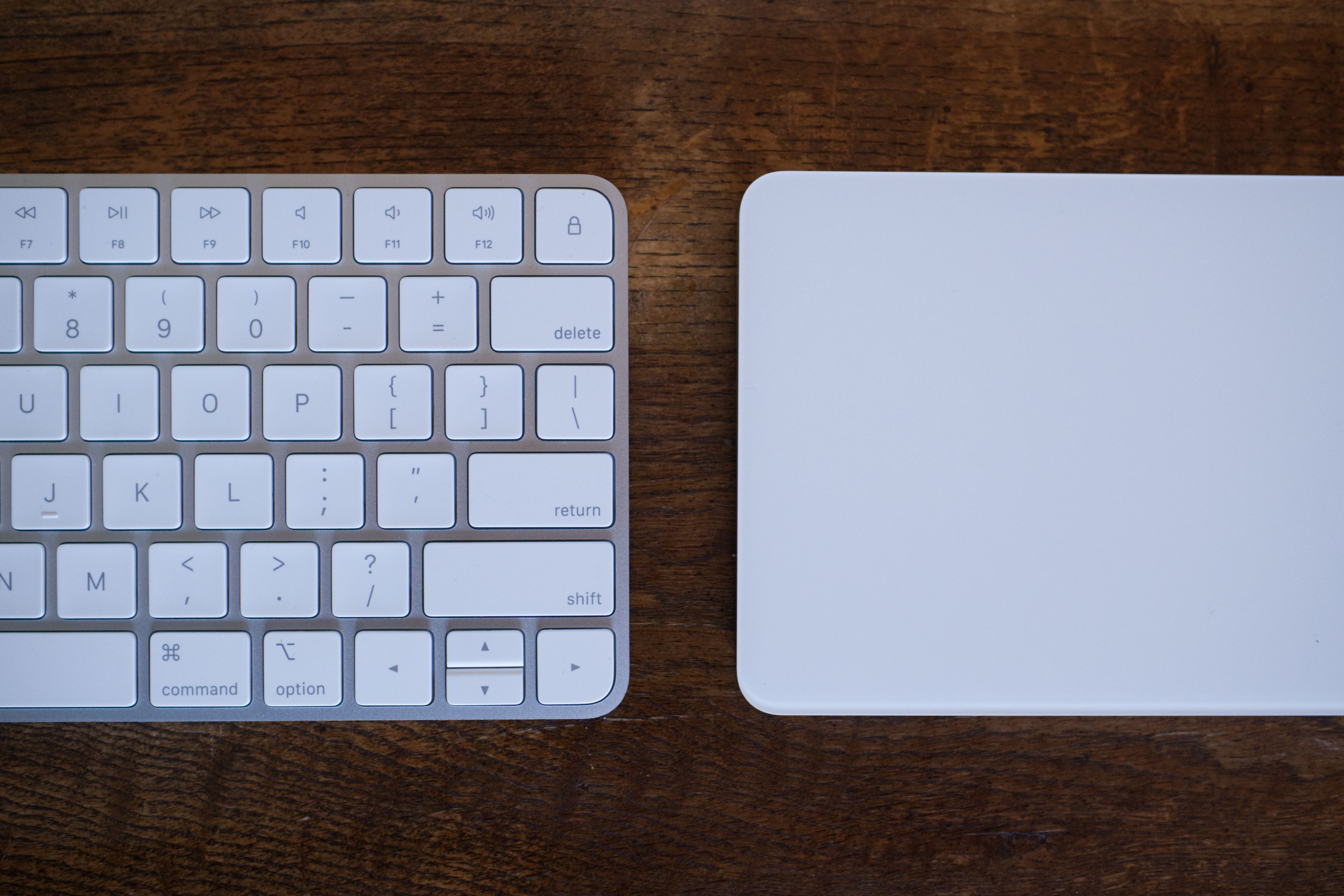 Apple Magic Keyboard and Apple Magic Trackpad side-by-side.