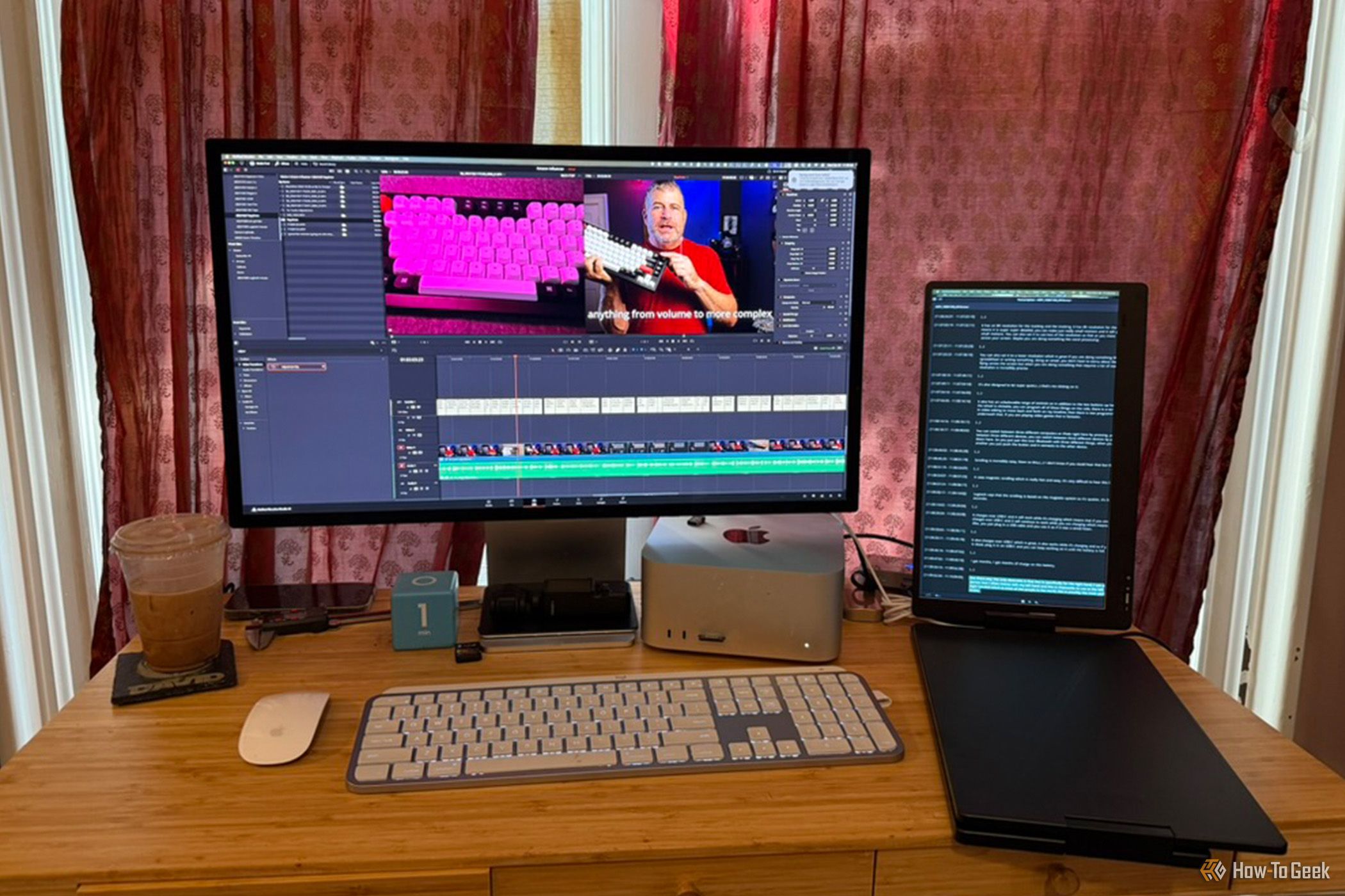 A Mac Studio and Apple Studio Display on an office table with a secondary screen in portrait mode to its right.