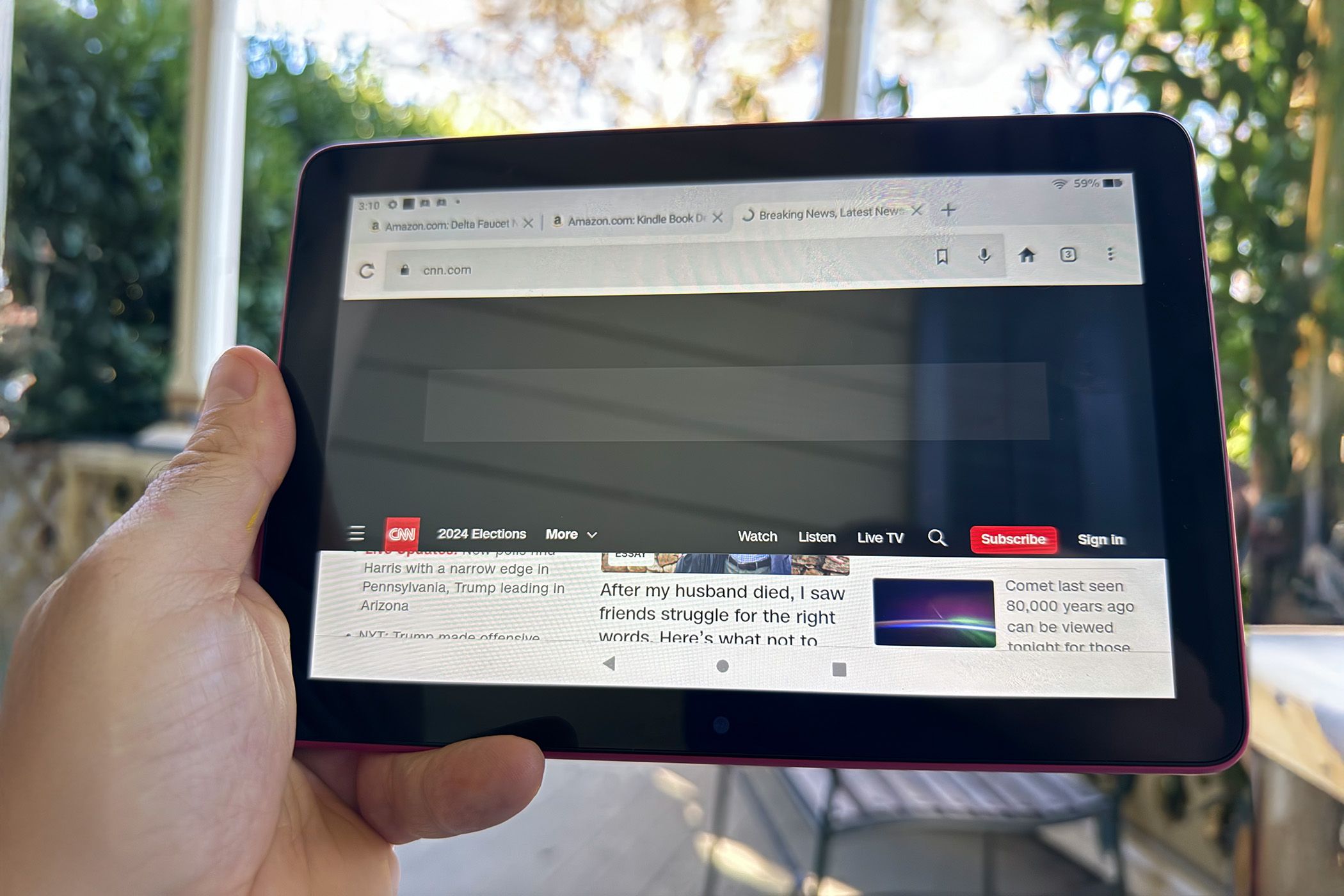 The Amazon Fire HD 8 showing the CNN website. The top portion of the site is black.