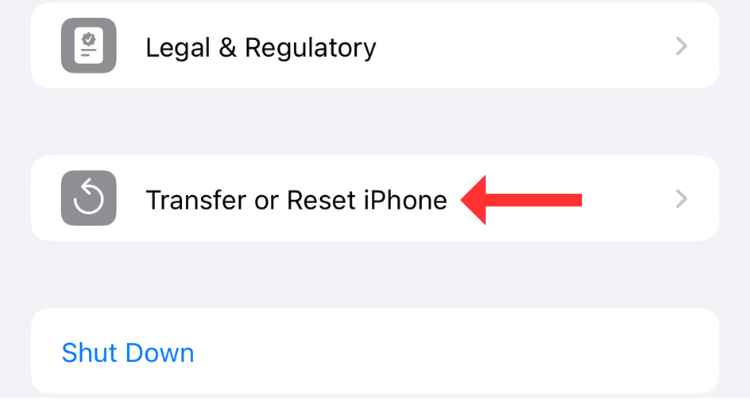 Screenshot of the General settings menu in iPhone with an arrow next to the transfer or reset iPhone button.